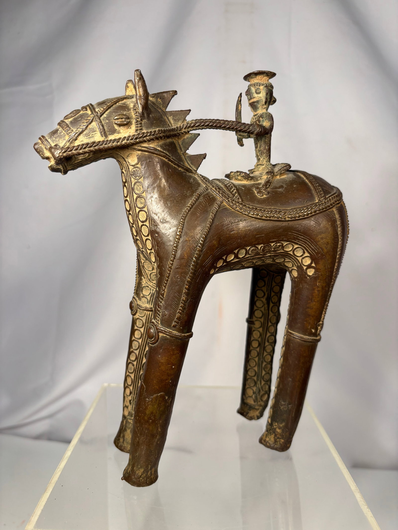Indian Dhokra Bronze Horse with Tribal Riders, Lost-Wax Cast: Vintage Indian Dhokra bronze horse sculpture with tribal rider, handcrafted using the traditional lost-wax casting technique. The stylized horse is richly decorated with incised geometric motifs and i