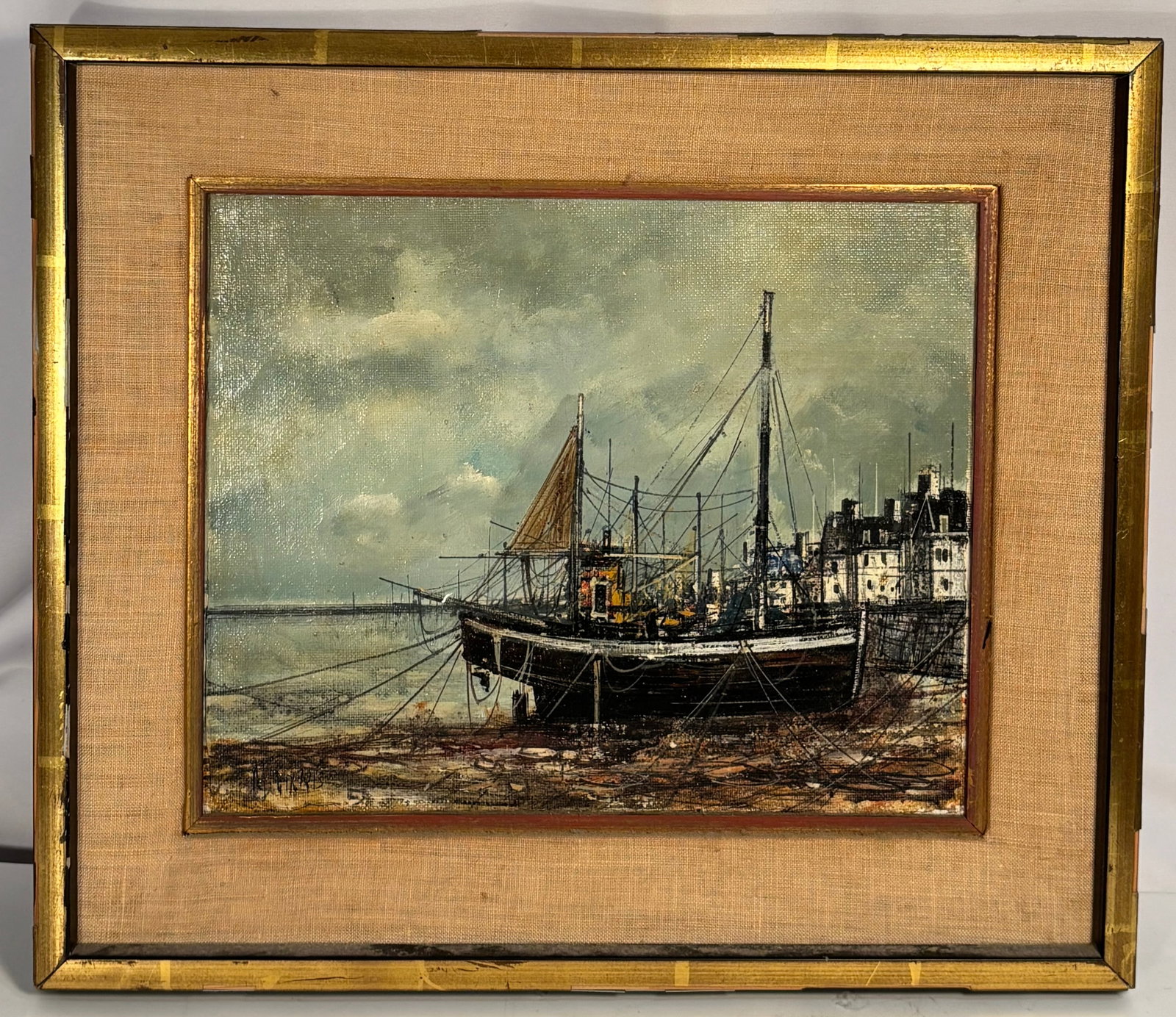 Michel Girard (French, 20th Century) Harbor Scene Oil on Canvas: Original oil on canvas depicting a European harbor with fishing boats moored along the waterfront beneath an overcast sky. Executed with expressive brushwork and a subdued coastal palette, the composi