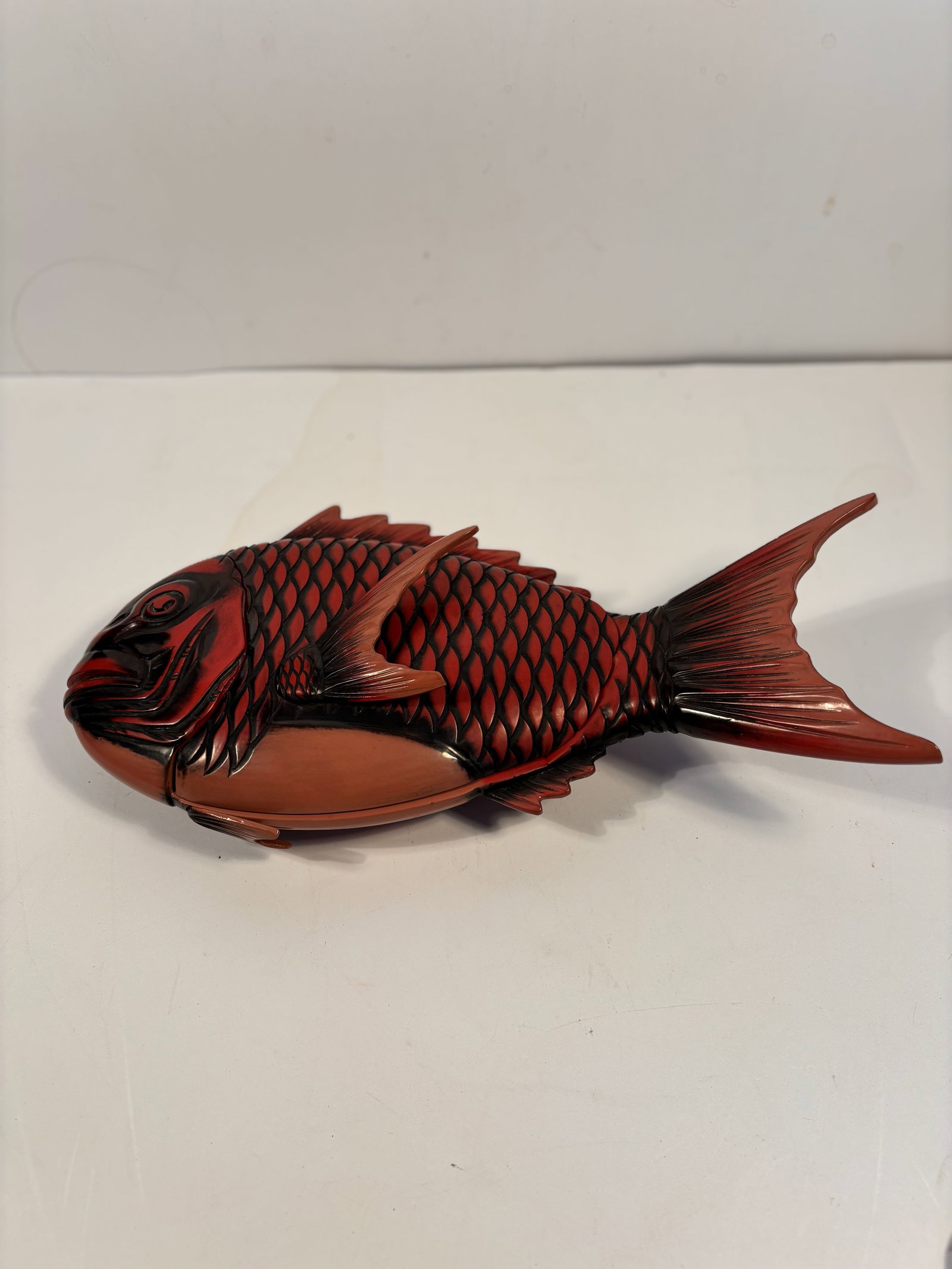 A Zohiko Kamakura Bori Japanese carved lacquer fish box: 19th century; Dimensions?15 Inches L X 7.5 W X 2,5H.