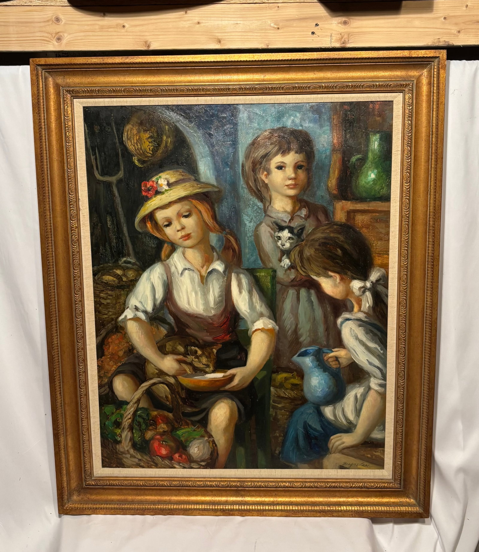 Jose Buigas (Spanish, 1927-?), Oil on Canvas Depicting Children with Kitten: Oil on canvas painting depicting three young children gathered in a rustic interior setting. One child cradles a kitten while another holds a blue pitcher, with baskets of produce and household object
