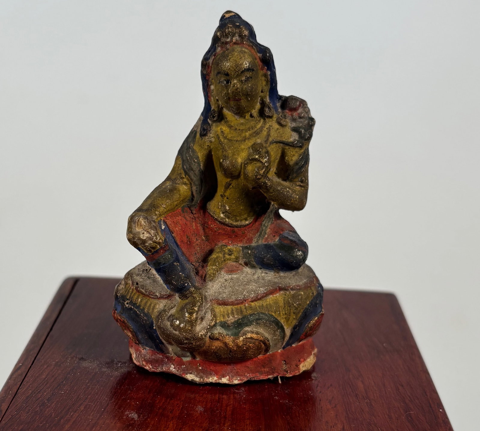 Tibetan terracotta tsa-tsa female bodhisattva figure: 19th century , The right leg is extended downward, which is a classic posture for Green Tara, the compassionate savior deity in Tibetan Buddhism. Dimensions?Height: 3 inches.