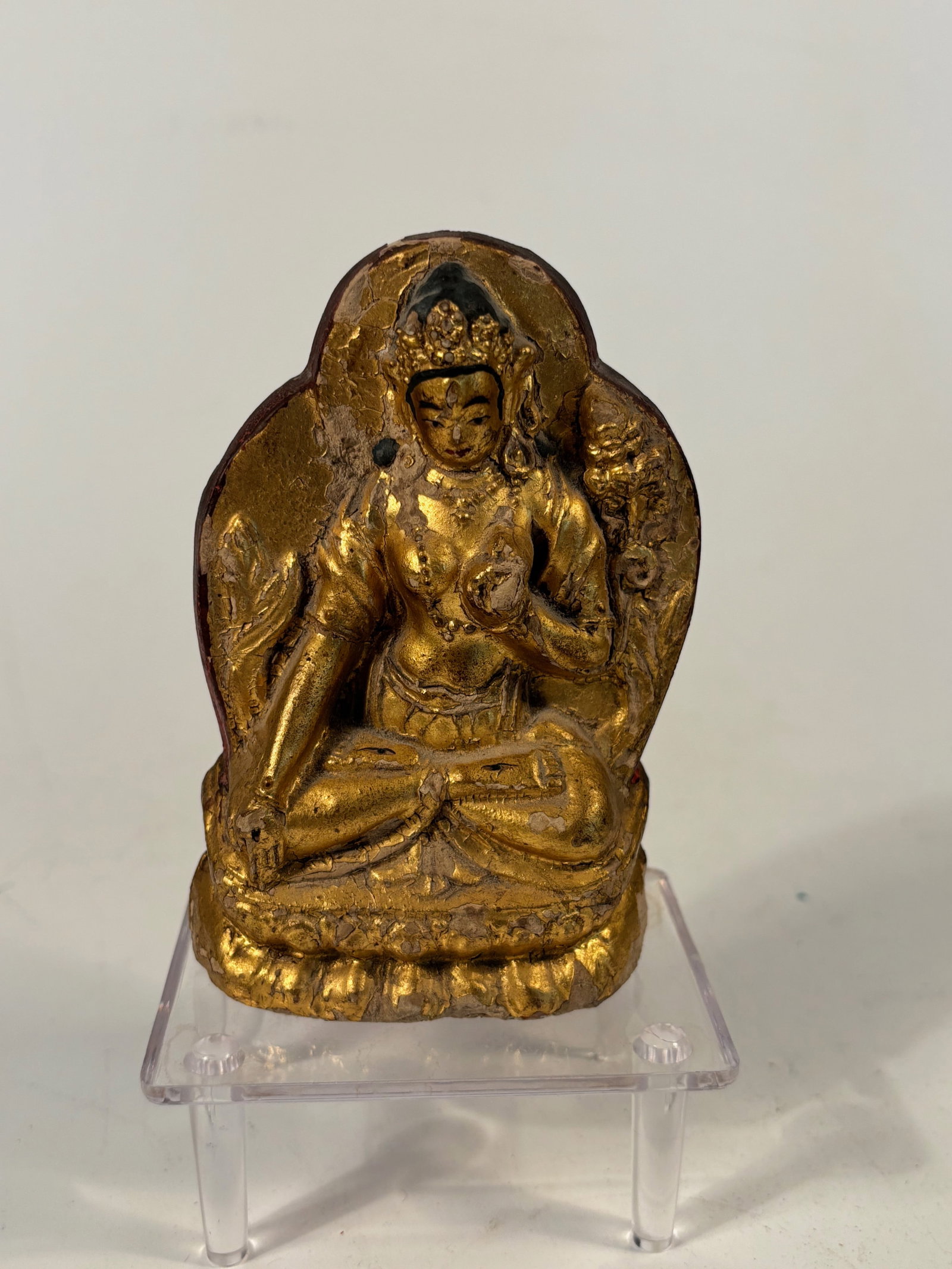 A Marvelous Tibetan Gilt-Lacquered Clay Figure of Bodhisattva Caca: Qing dynasty(1644-1912); Modeled seated in dhyanasana on a double lotus base, the figure with a serene expression, the right hand in varada mudra and the left in vitarka mudra. Adorned with a foliate 