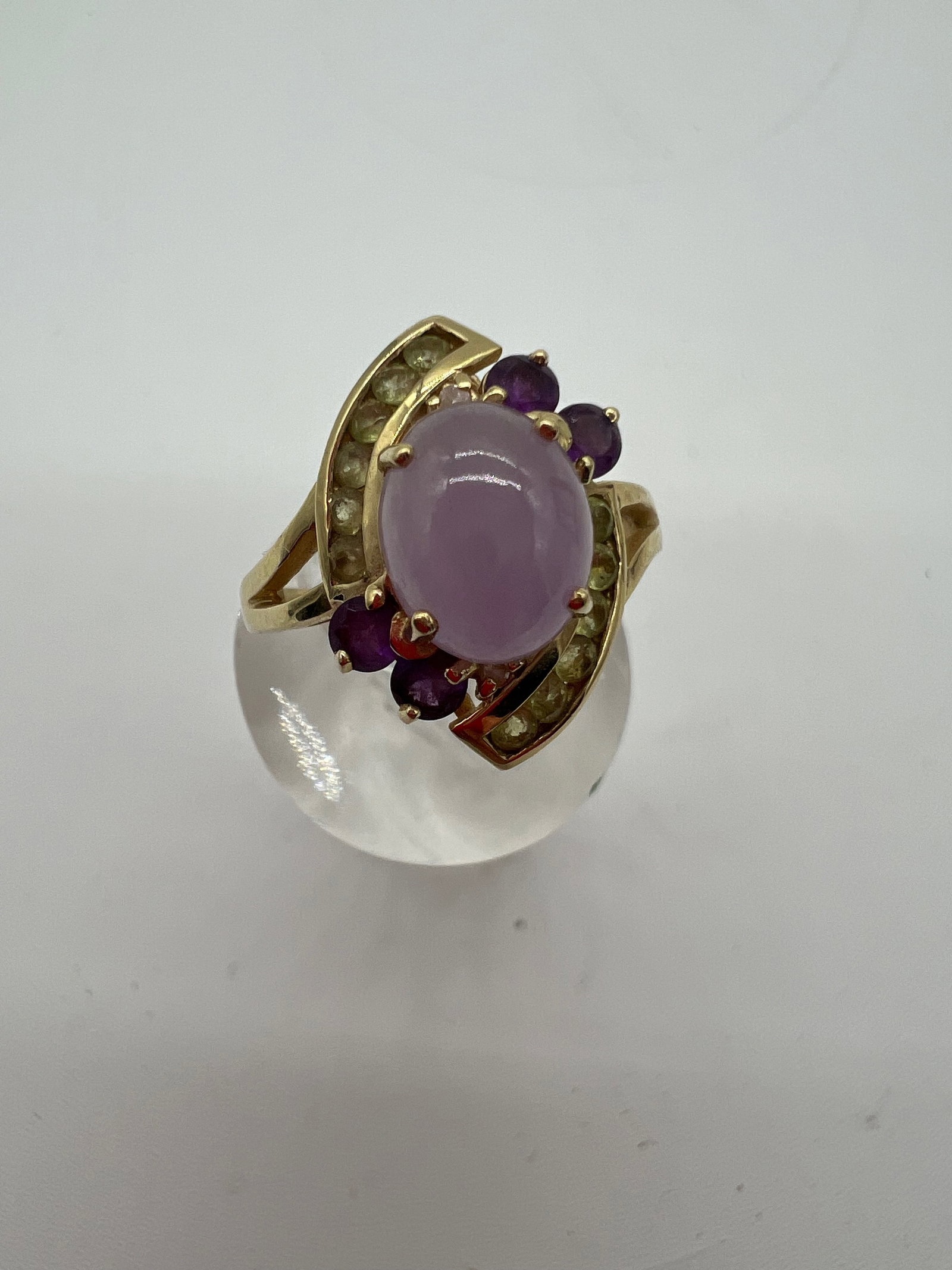 A Vintage Lavender Jade & Amethyst Ring 14K Yellow Gold: Ring set with lavender jade shape center 20x18mm and round amethyst gem stone and citrine mounted in 14 kt yellow gold; Dimensions?Total weight: 4.8g;Size 7.5 (U.S size) ; lavender jade shape center