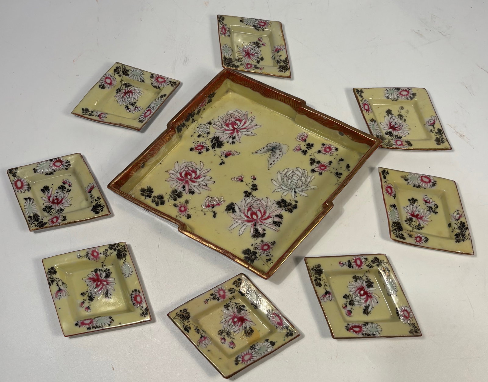 Japanese Yellow-Ground Porcelain Square Dish Set, Meiji Period (Late 19th Century): Japanese porcelain sweetmeat set, Meiji period (late 19th century), comprising eight small square dishes fitted within a larger square serving plate. Decorated on a yellow ground with polychrome
