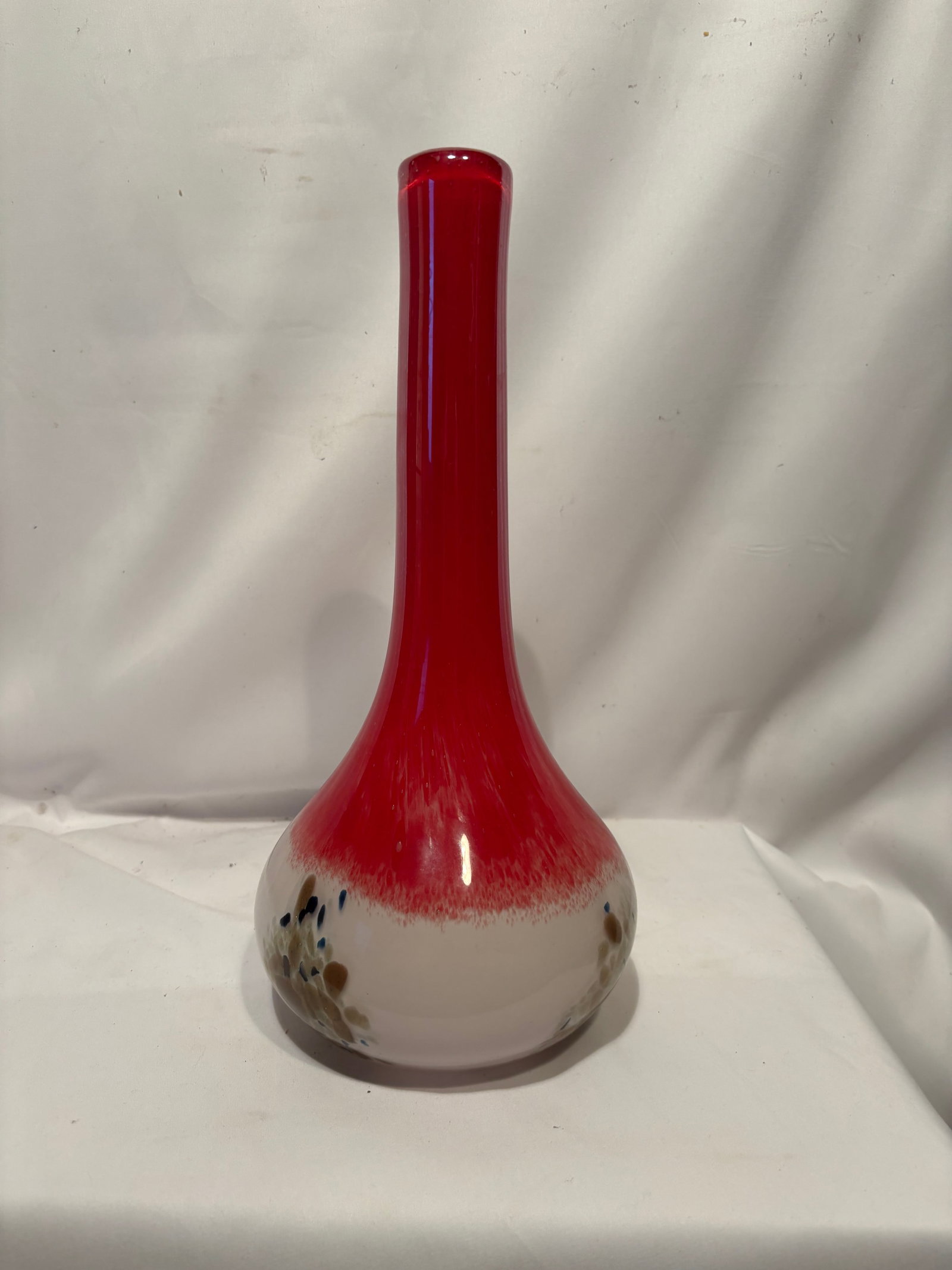 Hand Blown Art Glass Bud Vase with Aventurine Decoration: Hand-blown art glass bud vase featuring a vibrant ruby-red elongated neck above a rounded body of frosted white glass. The lower section is decorated with aventurine-style gold inclusions and contrast