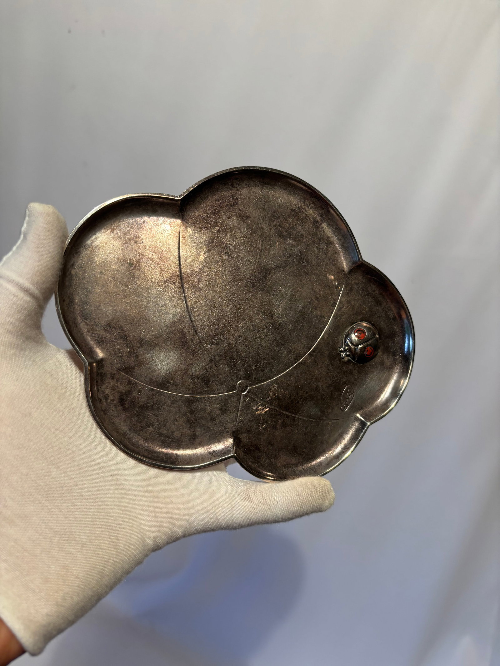 Japanese Sterling Silver Plum Blossom Tray with Ladybug Decoration: Elegant Japanese silver tray in the form of a five-petal plum blossom, featuring a finely modeled ladybug ornament with red inset eyes. Marked on the underside with a Japanese maker’s seal. A charmi