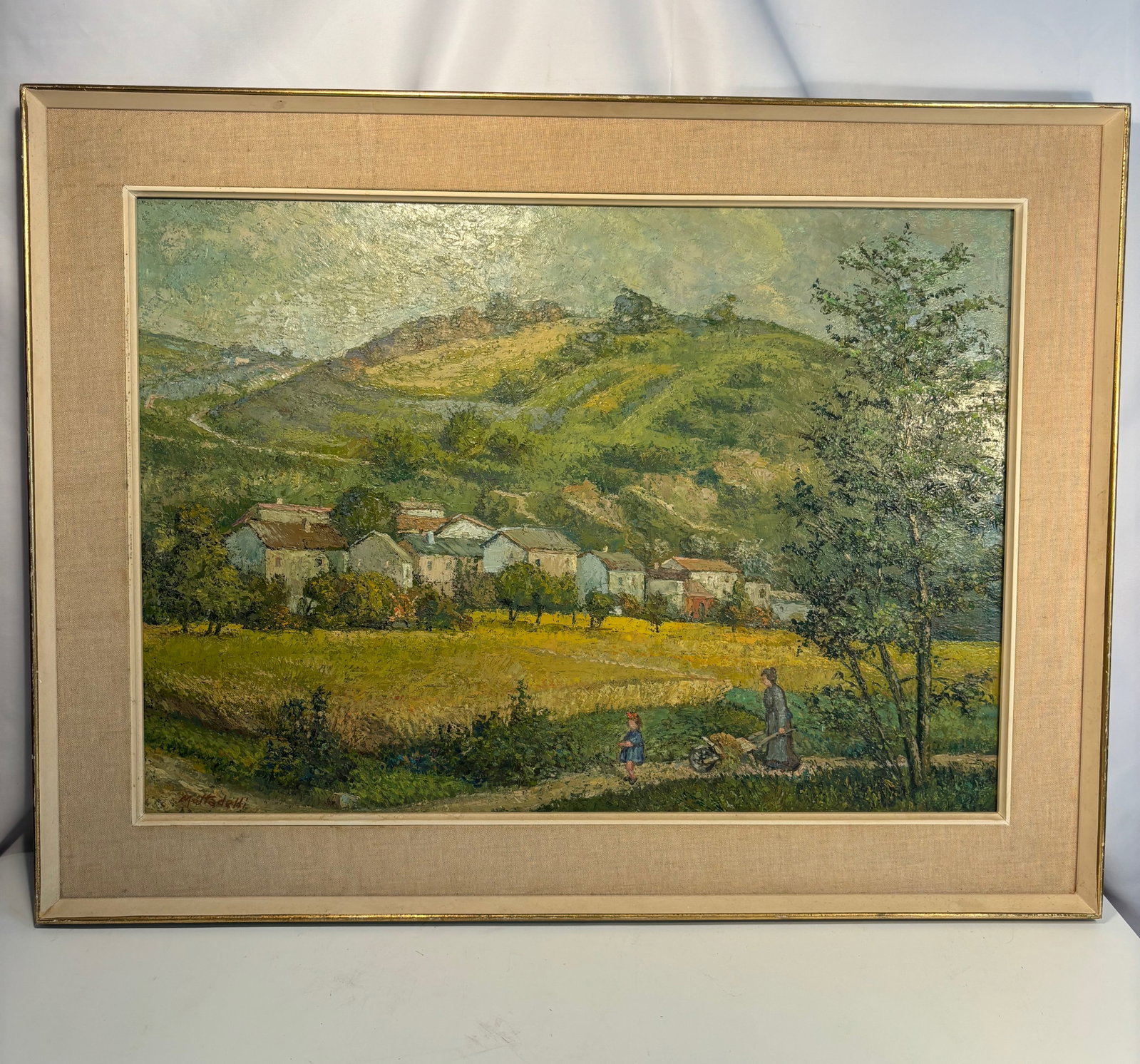 Giuseppe Mottaedelli (Italian, mid-20th century) , Village in the Hills, Oil on canvas, signed on: A vibrant Italian countryside scene depicting a cluster of houses nestled among green rolling hills under a luminous sky. Executed with thick impasto and confident brushwork, the painting captures the