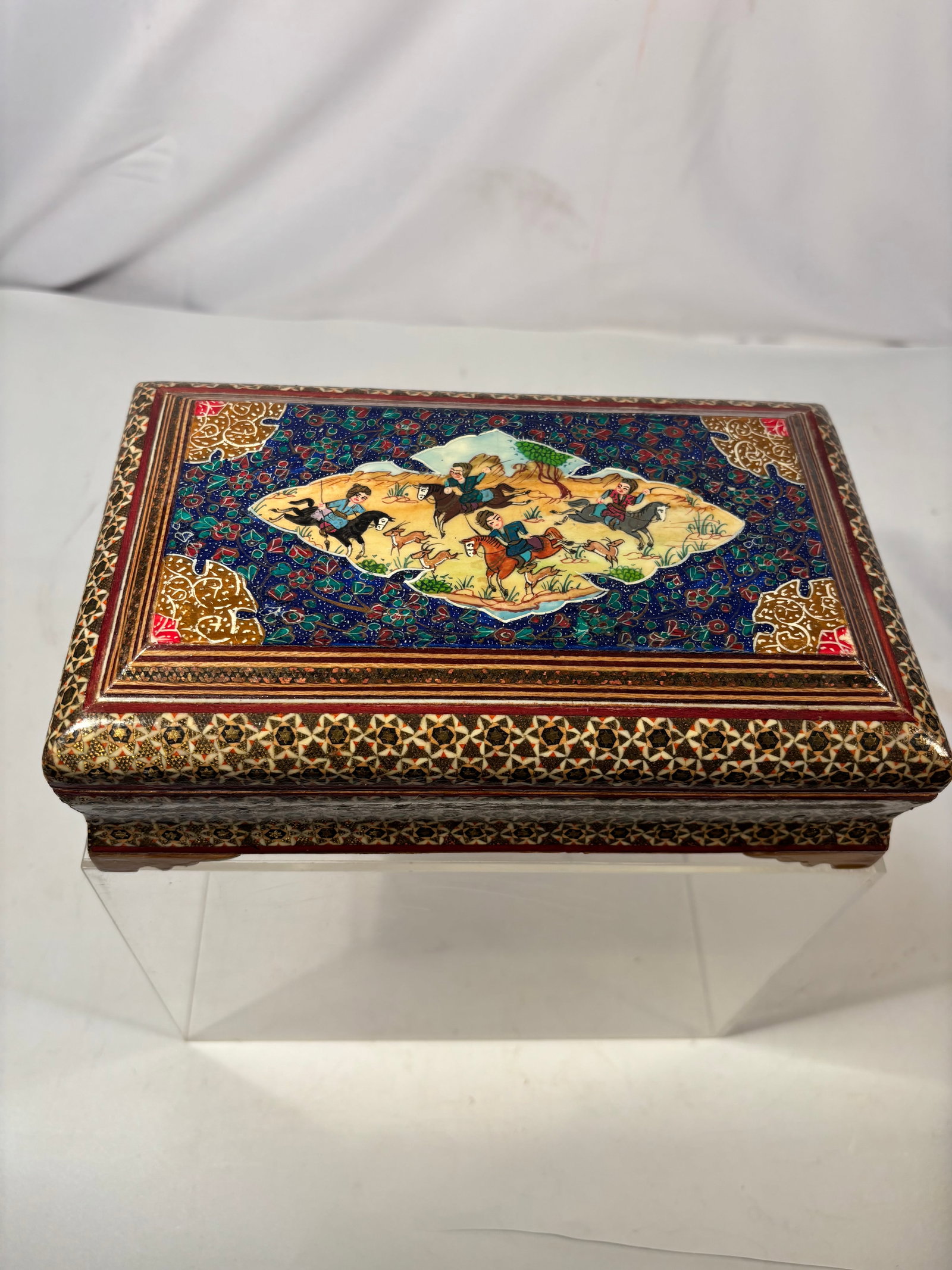 Vintage Persian Iranian Khatam-Kari Micro-Mosaic Box with Hand-Painted Hunting Scene: A finely crafted vintage Persian khatam-kari rectangular box, featuring intricate micro-mosaic inlay composed of wood, bone and brass arranged in repeating geometric star patterns. The hinged lid is c