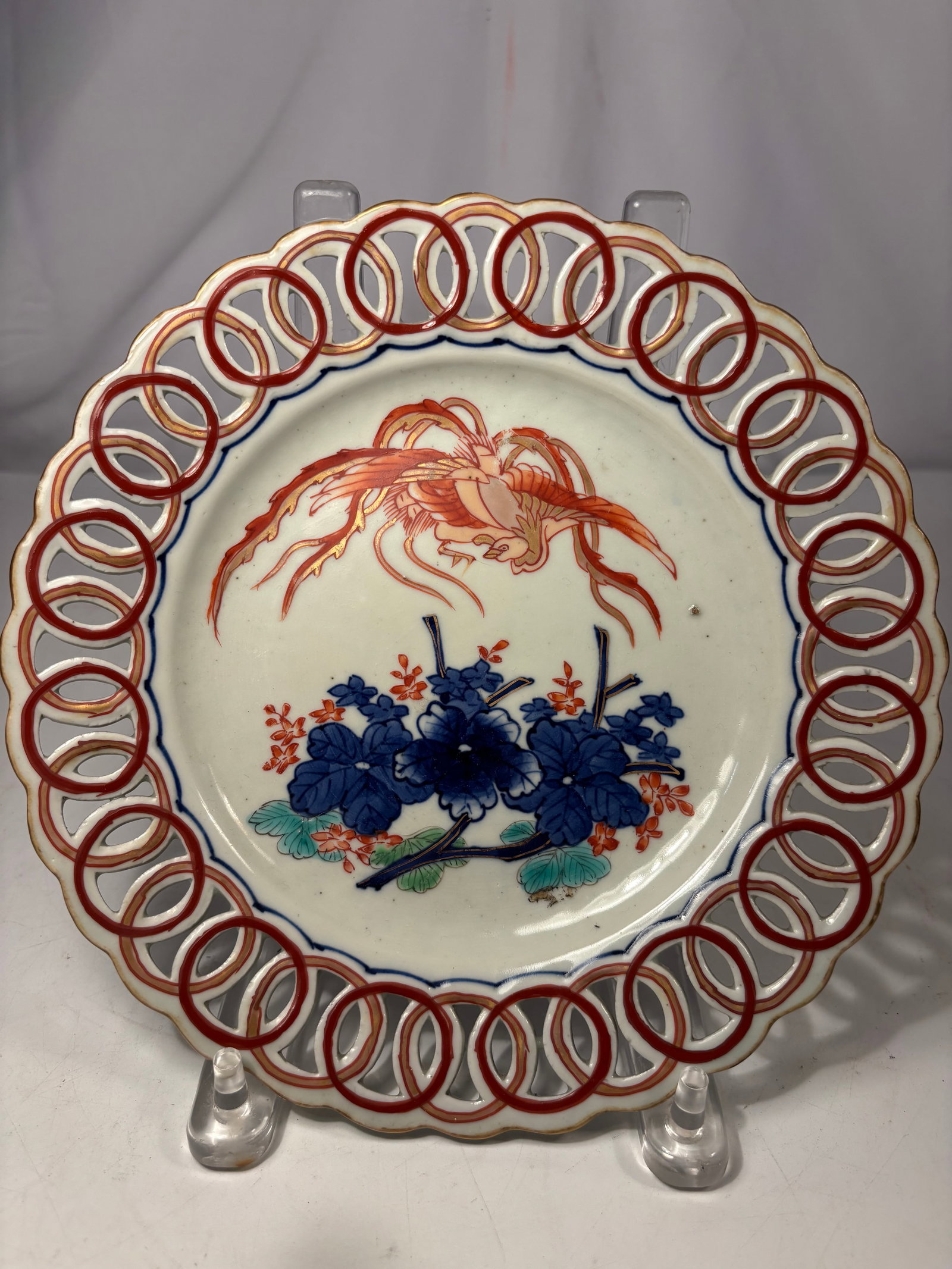 Japanese Arita Reticulated Porcelain Plate, H?-? Phoenix & Peonies, 20th C.: This striking mid-to-late 20th-century Japanese Arita Imari porcelain plate is a spectacular example of traditional Sukashibori openwork art. The hand-painted central medallion depicts a majestic
