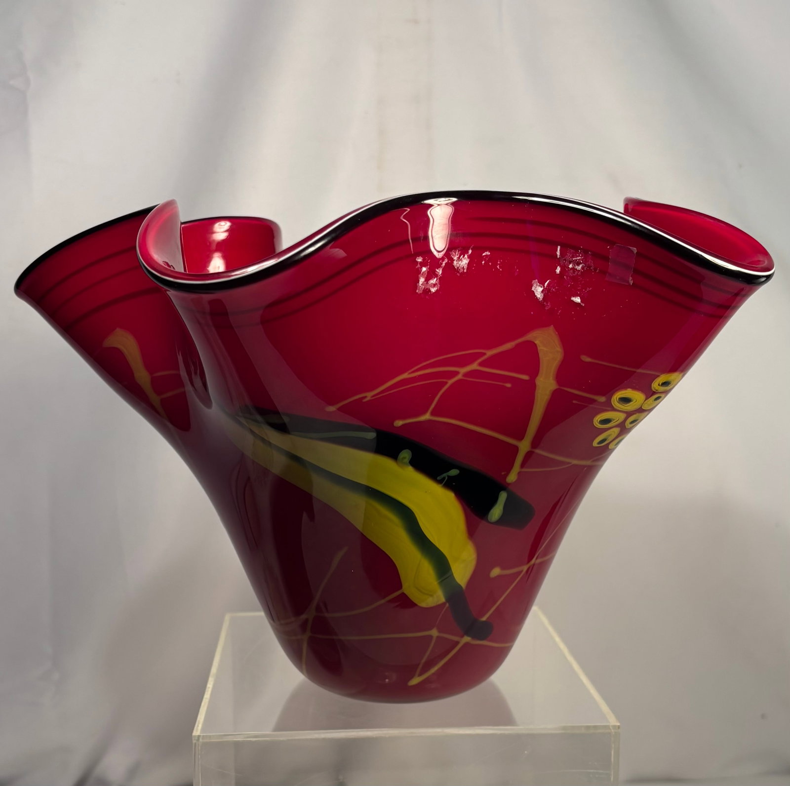 Contemporary Hand-Blown Ruby Red Art Glass Ruffled Vase with Abstract Decoration: Hand-blown contemporary studio art glass vase featuring a vibrant ruby red body with a dramatic freeform ruffled rim. Decorated with abstract applied black, yellow, and gold accents in a modern artist