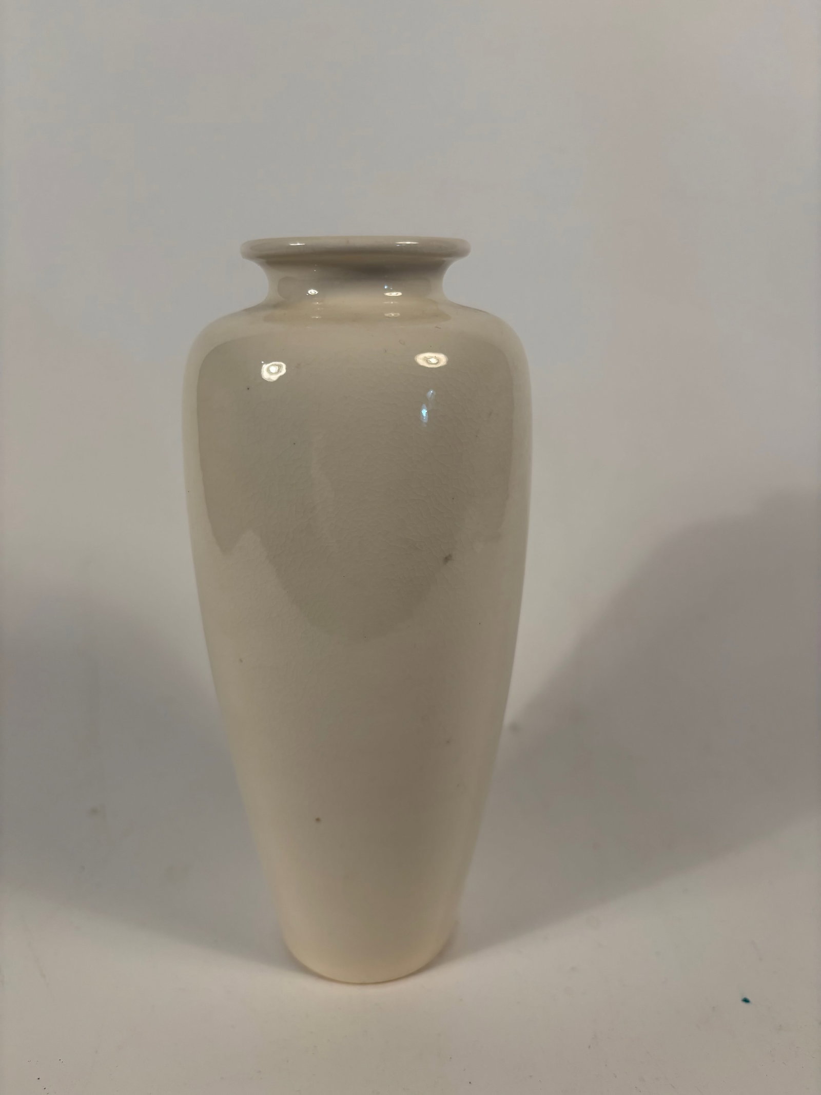 A Chinese blanc-de-chine vase: Qing dynasty(1644-1912); Even ivory to pale cream glaze, A clean, elongated baluster form with a short neck and flared mouth. Dimensions?Height: 7.25 inches.