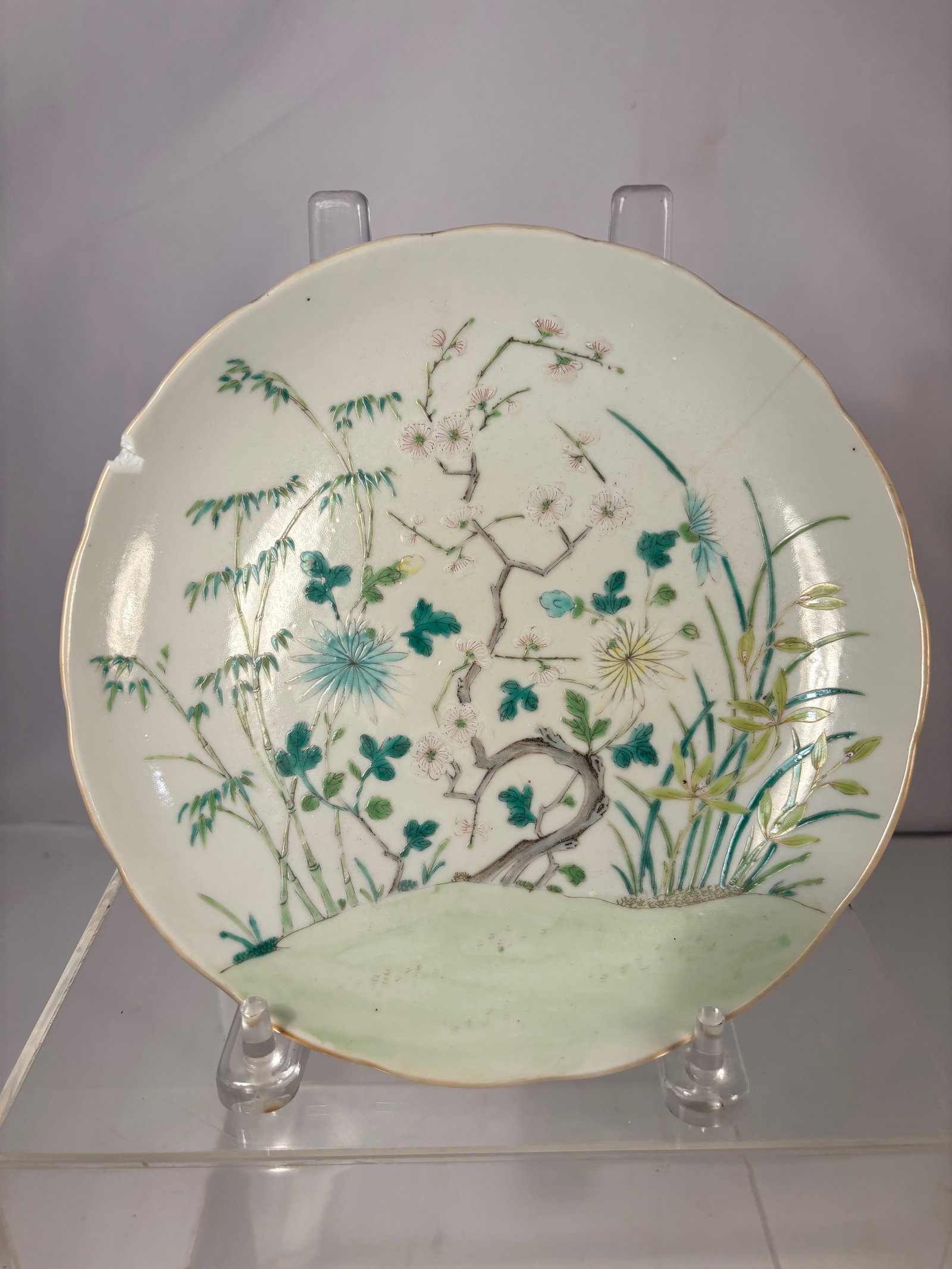 A Chinese Porcelain Plate with Floral Landscape Decoration with mark: Qing Dynasty (1644-1912) , Porcelain plate decorated in famille-rose–style enamels. The interior is finely painted with a tranquil floral and garden landscape, featuring delicate blossoms, foliage, 
