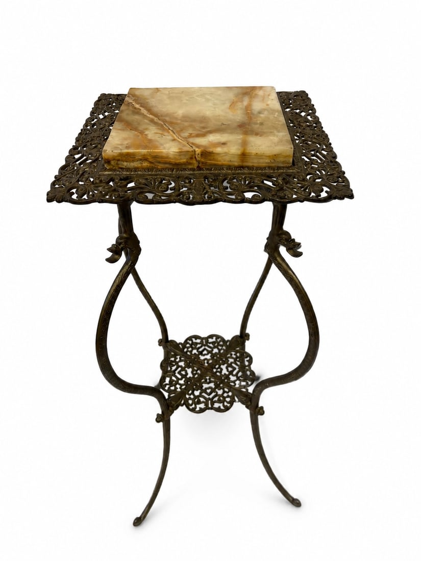 Antique Victorian Bronze and Onyx Pedestal Plant Stand: A tall decorative bronze pedestal stand featuring a square honey-colored onyx top surrounded by an elaborate pierced foliate gallery. The base is formed with scrolling lyre-shaped supports, figural ac