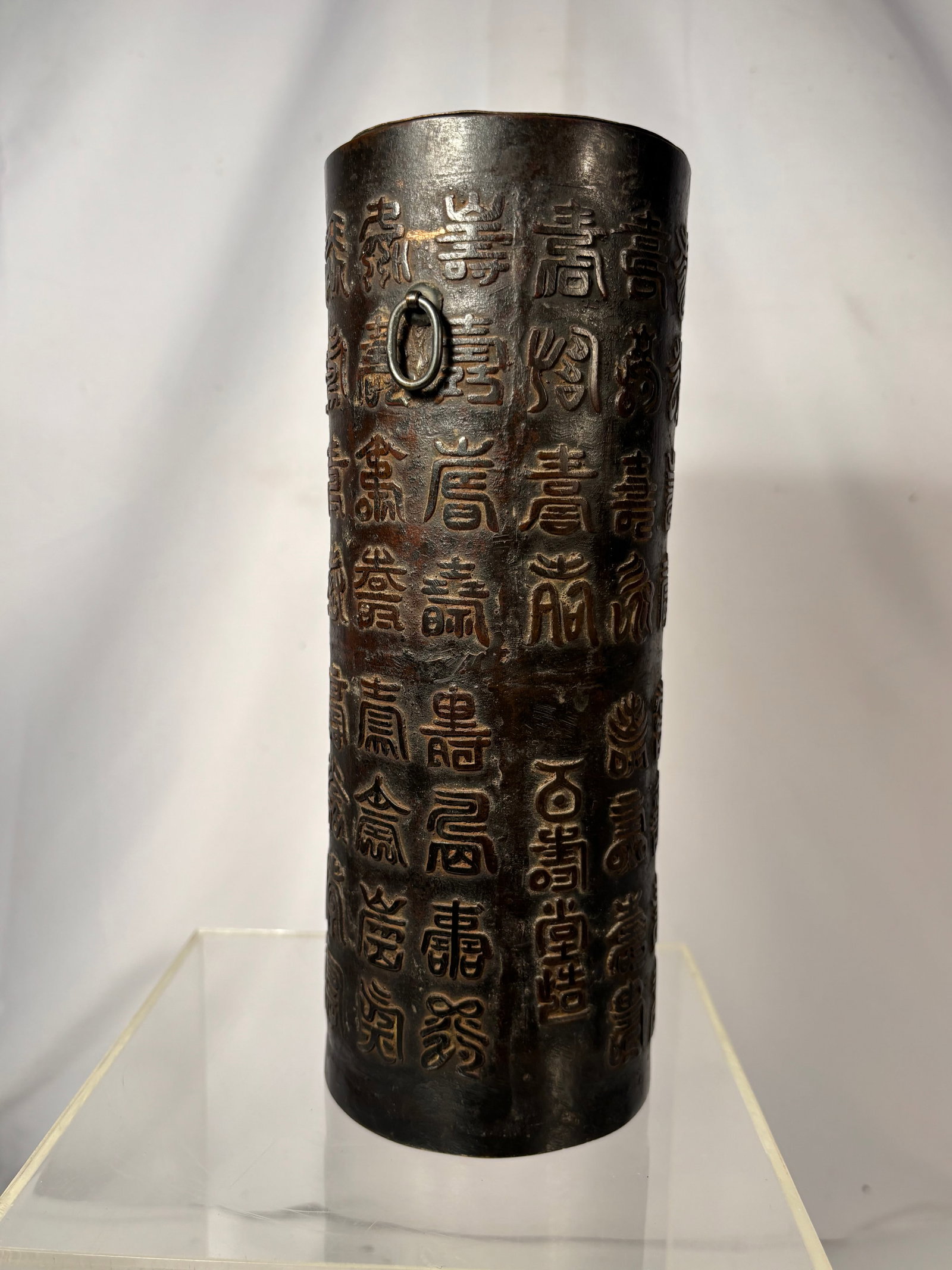 Chinese Bronze “Hundred Shou?? Wall Vase with Ring Handles 19th century ;: A Chinese bronze wall vase of elongated, gently tapered form, decorated throughout with numerous raised archaic and seal-script variations of the character “Shou,” symbolizing longevity. The dark 