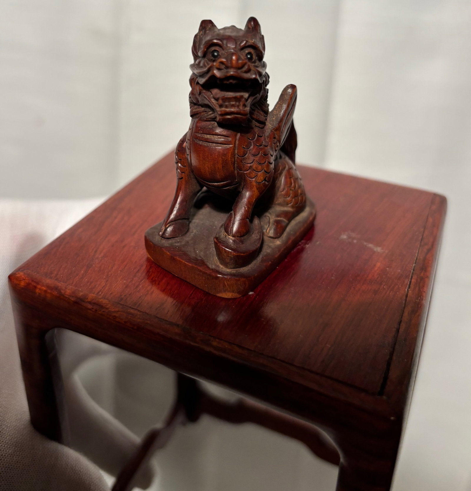 A Japanese Wood Netsuke of Pixiu (Mythical Beast), Signed "Furukawa": A finely carved Japanese-style wood netsuke, depicting a mythical beast resembling a Pixiu, rendered in a compact and expressive form. The figure displays detailed carving throughout, including textur