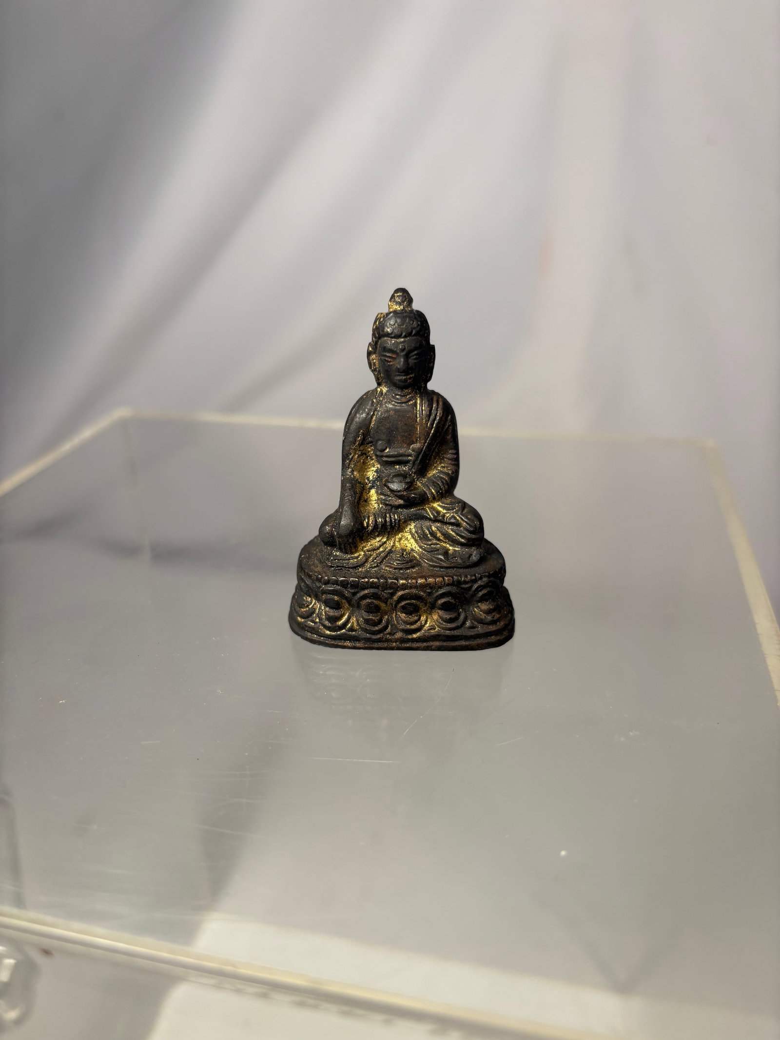 Tibetan Gilt-Bronze Figure of Shakyamuni Buddha 19th century: A 19th-century Tibetan gilt-bronze figure of Shakyamuni Buddha, seated in dhyanasana upon a double-lotus pedestal. The Buddha is depicted with his right hand extended in the earth-touching bhumisparsh