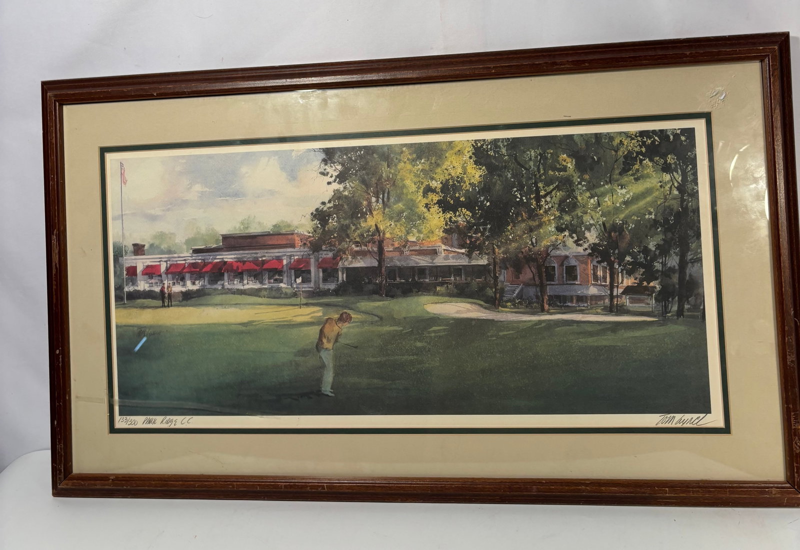 Tom Lynch Limited Edition Print “Park Ridge Country Club?? 133/200: A limited edition golf-themed print by Tom Lynch, depicting a golfer putting on the grounds of Park Ridge Country Club, with the clubhouse and landscaped greens beyond. Executed in the artist’s lumi