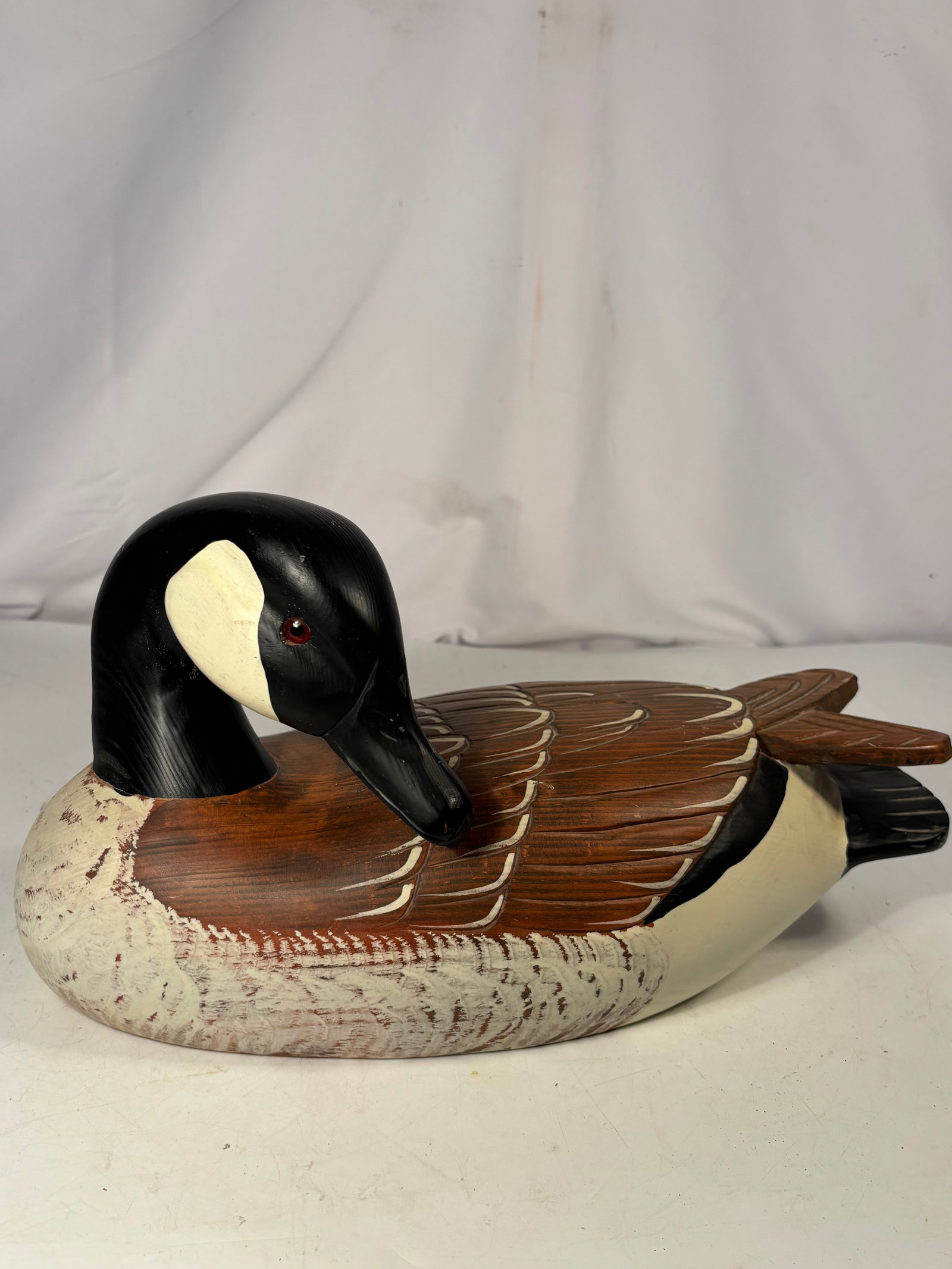Gary Lowenthal for The Boyds Collection “Hunter’s Goose?? First Edition Wood Decoy, 1980–1985: A vintage carved and hand-painted wooden Canada goose decoy by Gary Lowenthal for The Boyds Collection, depicted in a resting pose with its head turned toward the body. Detailed with carved feathering