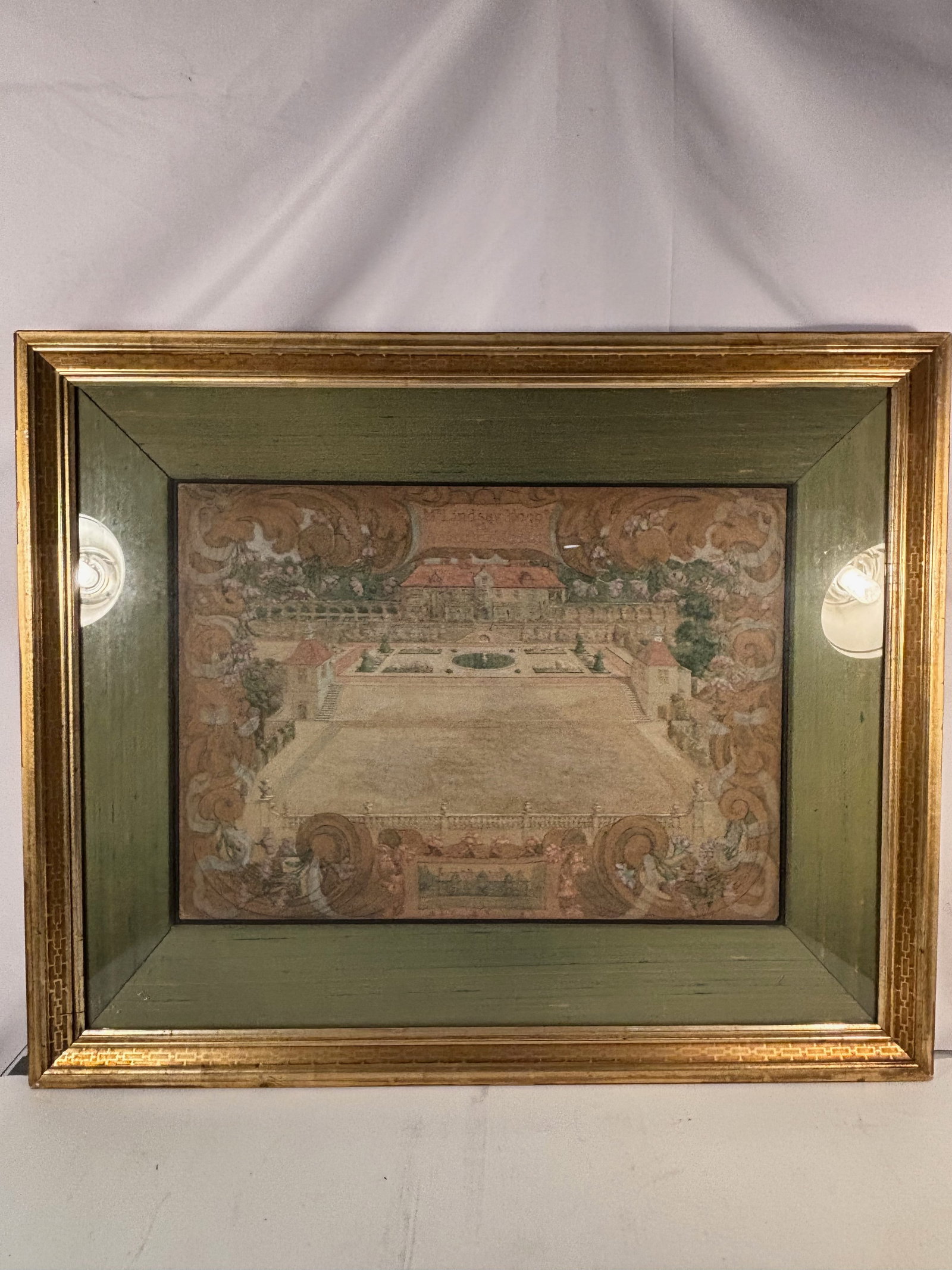 Mr. Lindsay Hogg’s at Rotherfield, Sussex , Unknown British artist ,Circa 1890 – 1910: A detailed bird’s-eye watercolor of a country manor and formal gardens, with terraces, fountains, and ornamental topiary framed within elaborate scrollwork and floral decoration. The ornamental cart