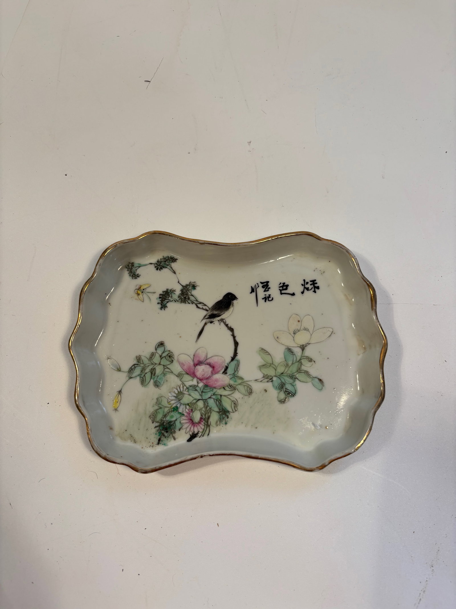 A Chinese famille rose porcelain ink-washer plate with Chinese Caligraphy: Late 19th to early 20th, features birds and flower motif. Dimensions?Length: 7 inches; Width: 5.25 inches;