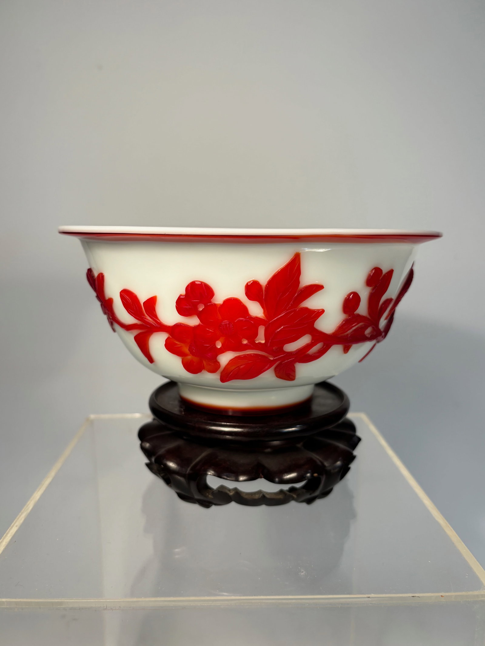 A Chinese Red Overlay Peking Glass Bowls: Qing Dynasty(1644-1912); A vibrant set of Chinese Peking glass bowls, each featuring rich red overlay carving on a solid white glass ground. The decoration includes a variety of traditional Chinese mo