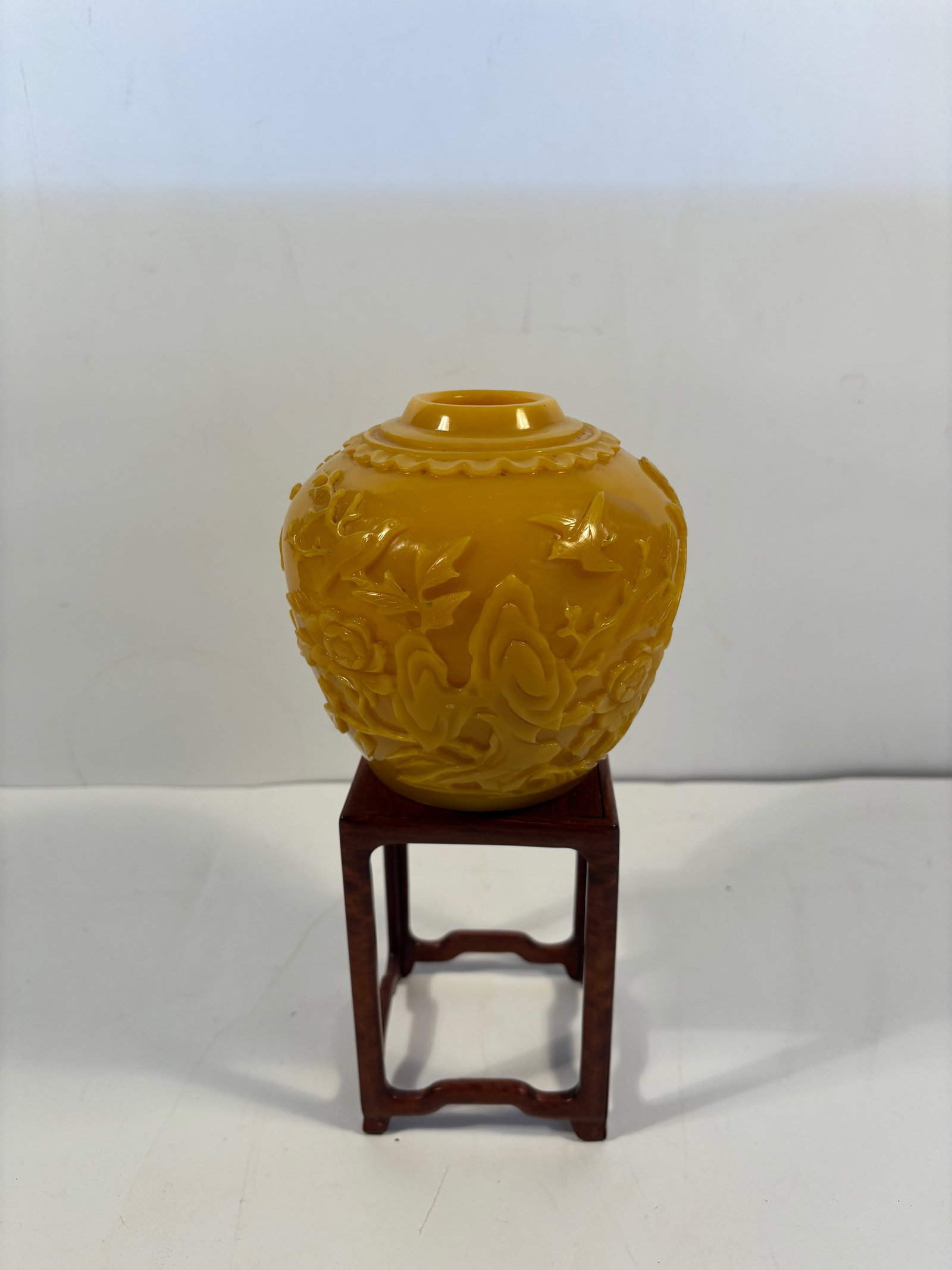 A Chinese yellow Peking glass vase: Qing Dynasty (1644-1912);The deep carving with flowing floral patterns looks quite sophisticated;The yellow color is bright and even, a desirable imperial yellow tone; The rim and base opening are smo