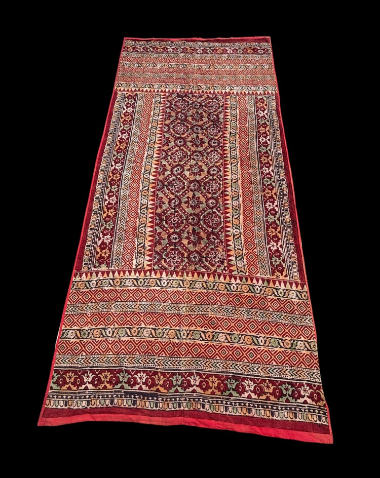 Vintage Indian Hand-Block Printed Cotton Prayer Textile with Red Backing 101 X 46 in.: A vintage Indian cotton textile, likely from Rajasthan or Gujarat, decorated with densely arranged floral and geometric motifs in deep red, black, ochre, cream, and muted green. The elongated composit
