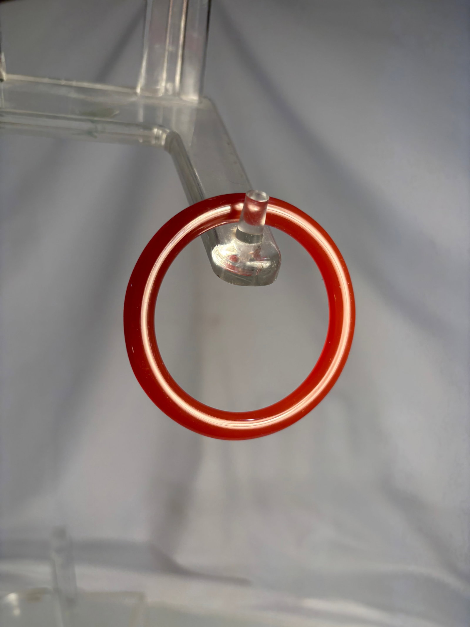 A Chinese Carnelian Agate Bangle Bracelet: Chinese carnelian agate bangle bracelet, finely polished with a rich translucent reddish-orange tone. Circular form with smooth rounded profile. The stone displays attractive natural color and translu