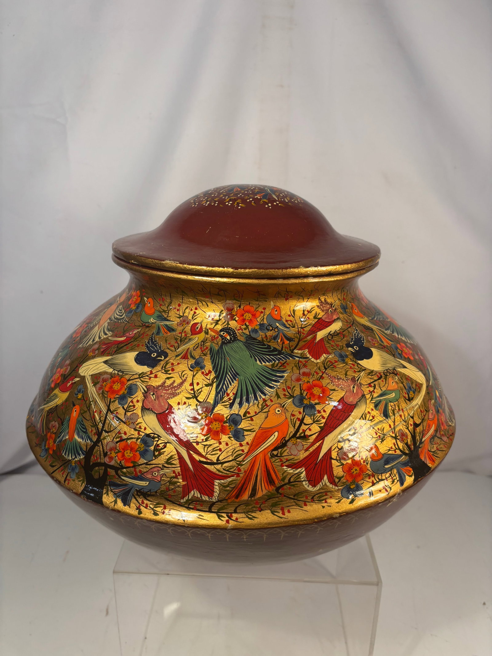 Large Persian Qajar Gilt and Polychrome Lacquered Wood Covered Vase with Birds and Flowers, 19th: A large Persian Qajar lacquered wood covered vase of compressed globular form, richly painted and gilt with numerous colorful birds among flowering branches in the traditional gol-o-bolbol style. The 