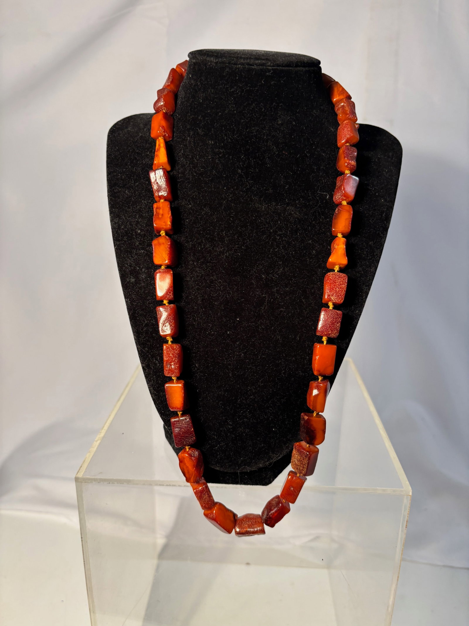 A Butterscotch Amber Beaded Necklace, Vintage Baltic Amber Style: A necklace composed of butterscotch amber-style beads in varied geometric forms. The beads display warm tones ranging from honey to deeper amber hues, with a soft, waxy luster characteristic of aged a