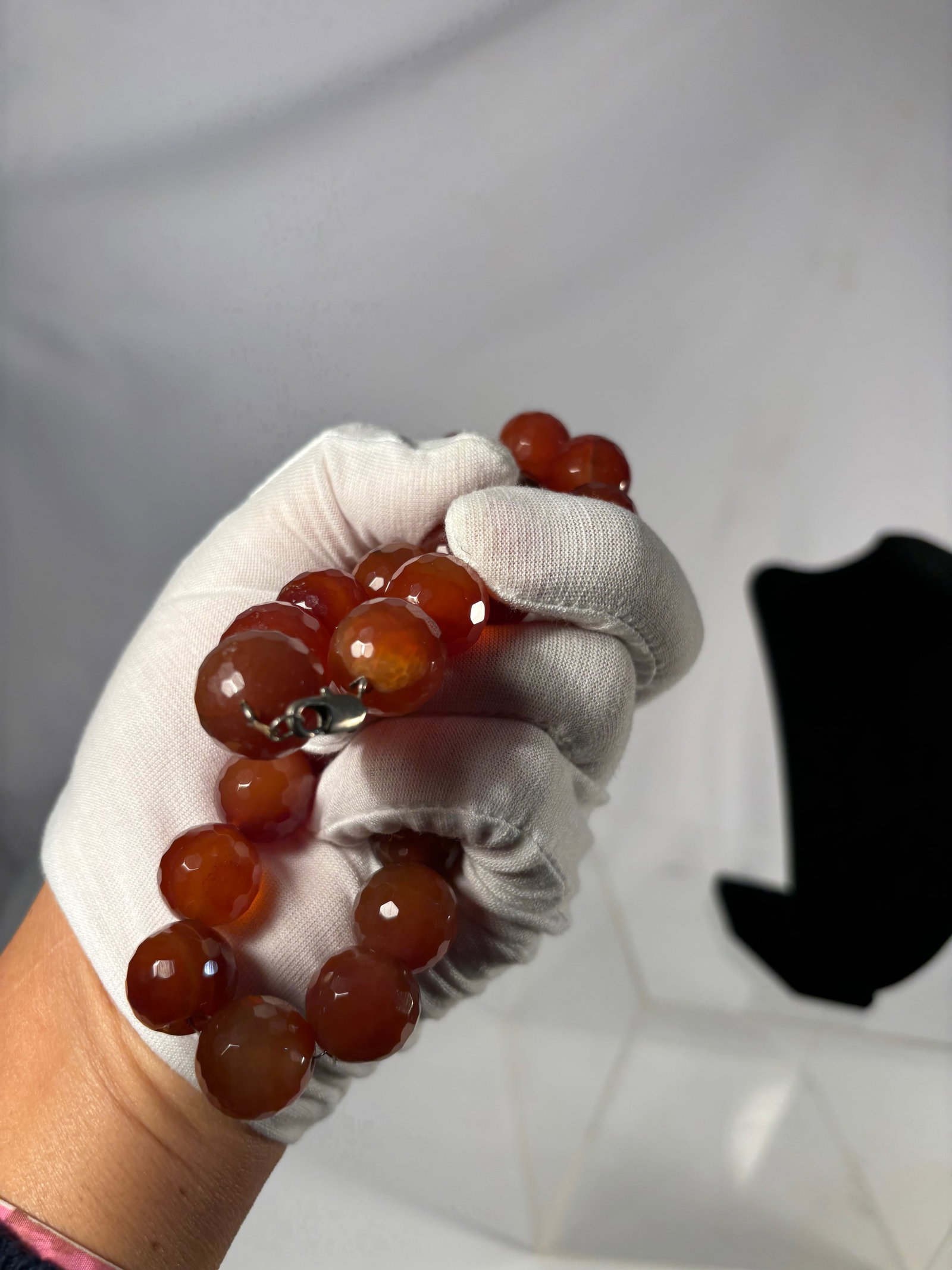 Large Faceted Carnelian Bead Necklace: A striking necklace composed of large faceted carnelian beads, each displaying warm orange-red tones with natural internal variations. The beads are well-polished with attractive translucency and ligh