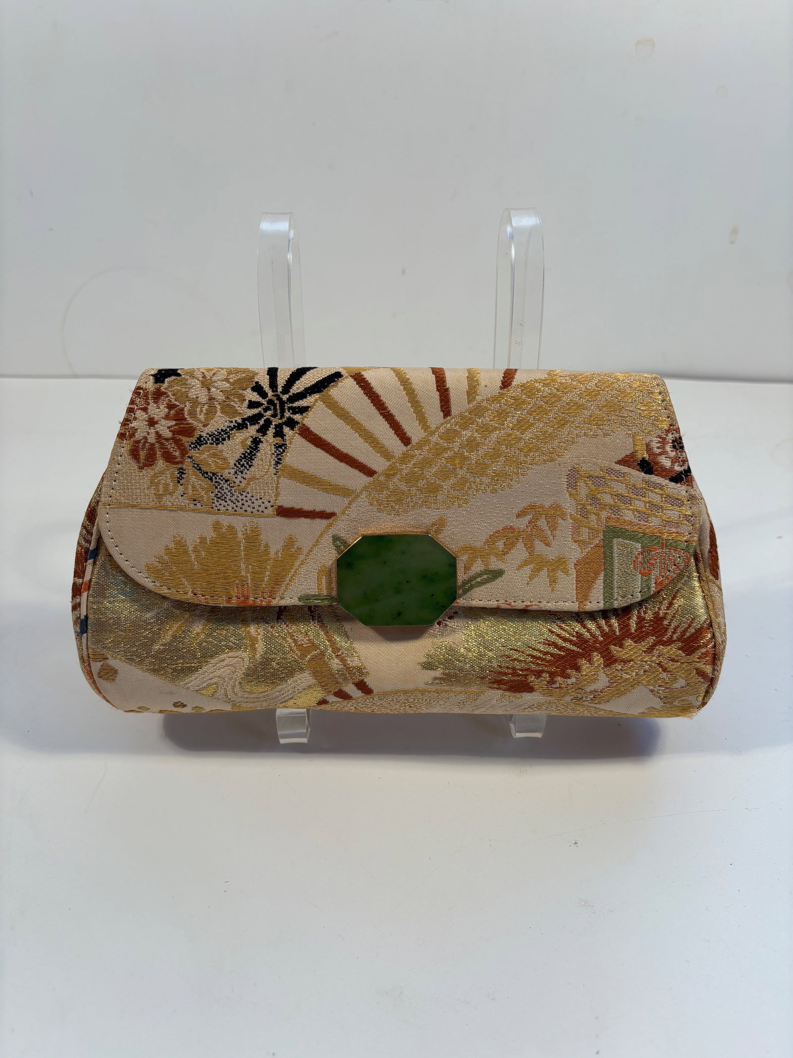 A Japanese Clutch purse with green jade clasp: The fabric appears to be silk brocade or rinzu (a traditional Japanese silk weave) with metallic threads, typical of obi textiles. Dimensions?Length: 9.5 inches.