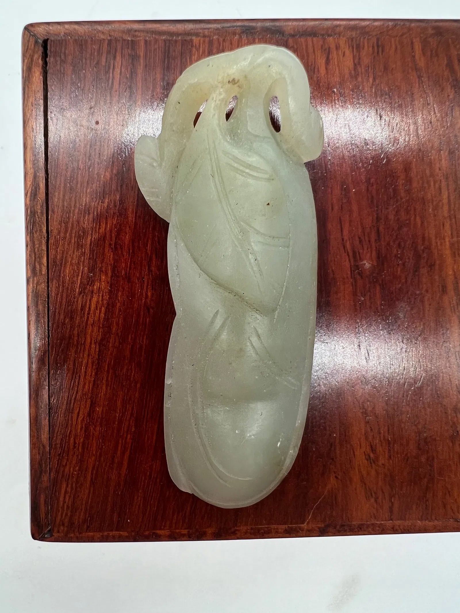 A Chinese hand carved celadon jade bean pendant. (1 of 6)