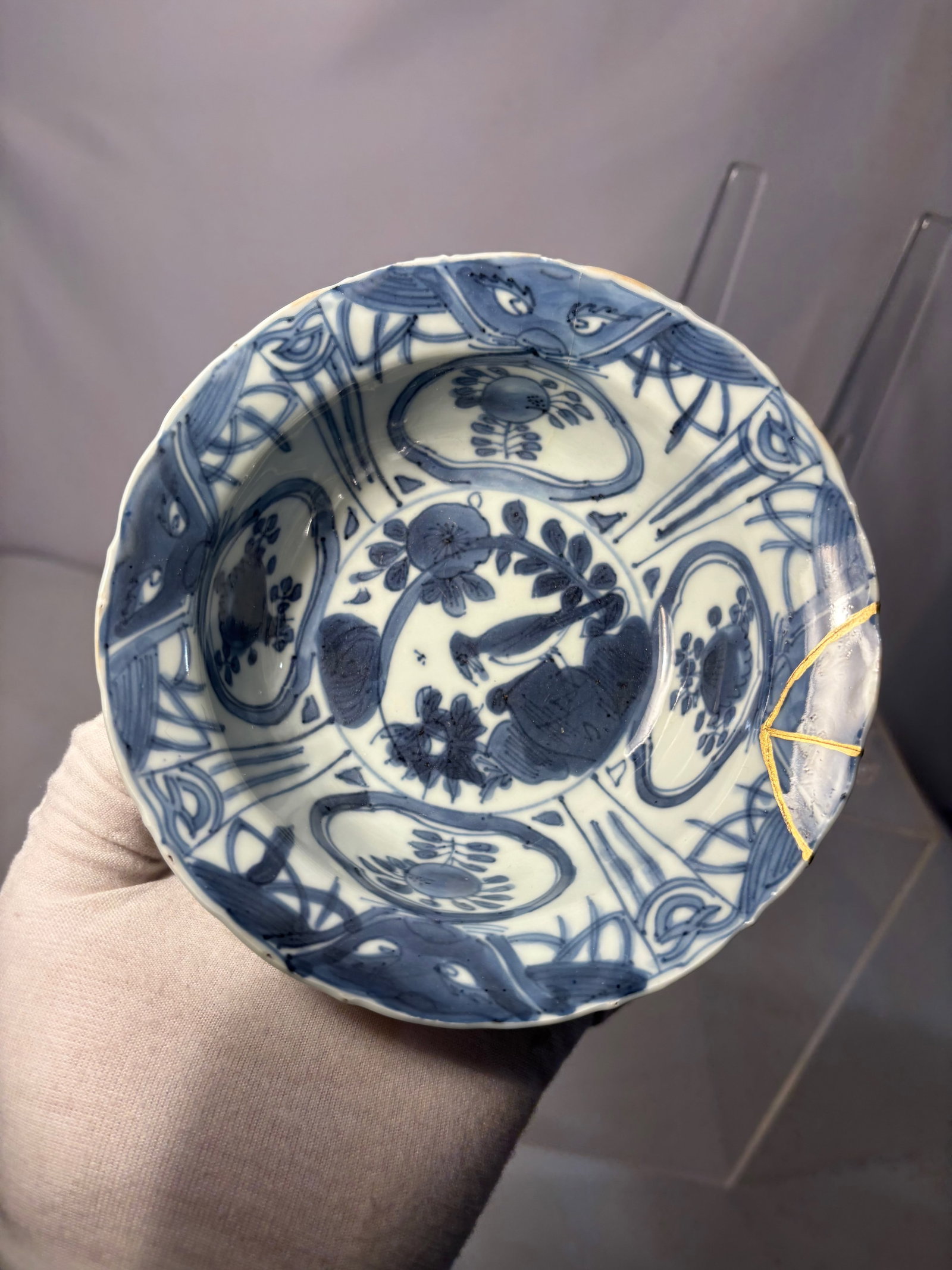 A Chinese Blue & White Porcelain Bowl with Kintsugi-Style Repair: Probably 16-17th century, A Chinese blue and white porcelain bowl decorated in the Ming style. The interior is painted with a central floral medallion surrounded by radiating panels and stylized motif