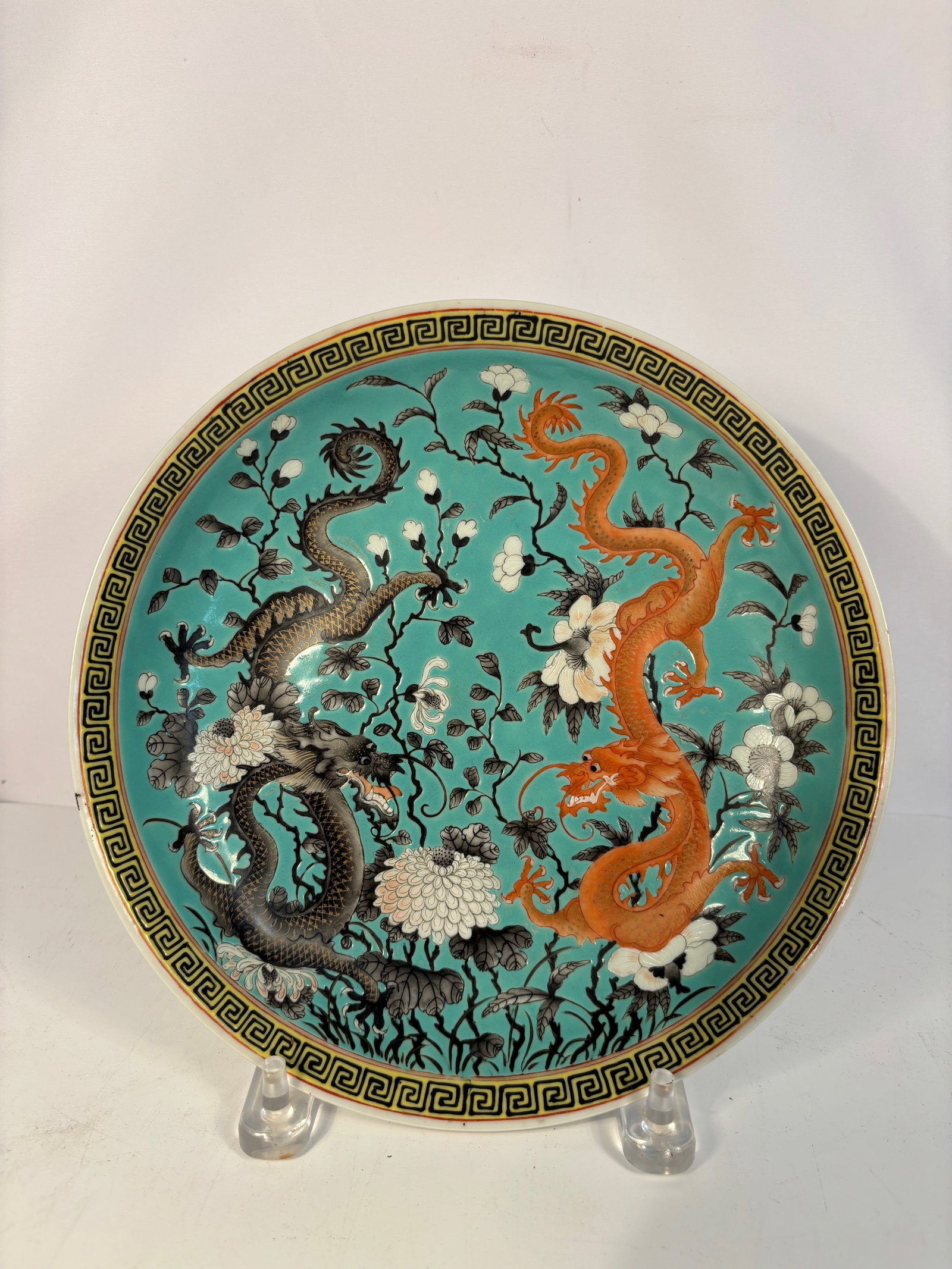 A Fine Chinese Turquoise-Ground Famille Rose Plate with Two Dragons and “Daoguang?? Mark: Qing Dynasty(1644-1912); A finely enamelled Chinese porcelain plate, decorated in famille rose enamels on a turquoise ground, depicting two five-clawed dragons—one iron-red, one black—chasing a fl