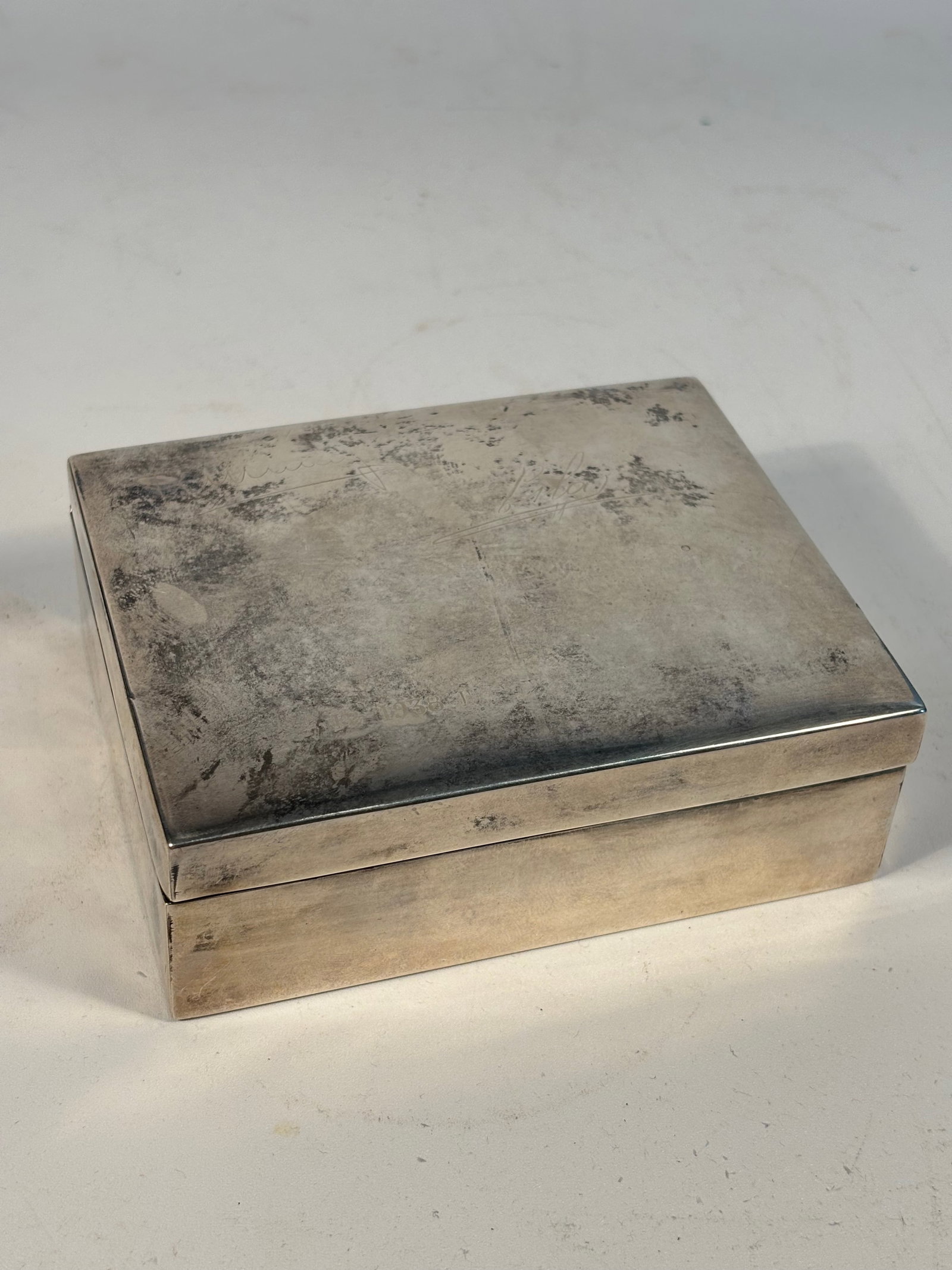 A Chinese sterling Silver and Huanghuali Box marked "HENGFENG": Qing Dynasty (1644-1912); The box is set on an inset panel of richly grained hardwood, likely huanghuali, prized for its deep tone and dense texture.This type of silver-and-wood combination box was po
