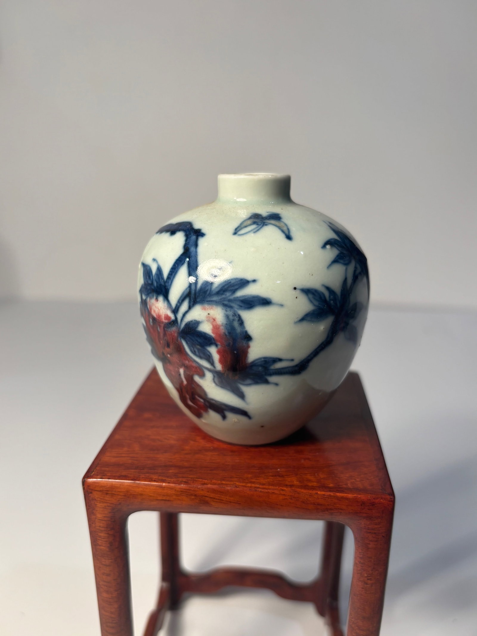 A Chinese Porcelain underglaze Iron Red and Blue snuff bottle with KANGXI SIX- CHARACTER at bottom: Qing Dynasty (1644–1912) ; The design on this snuff bottle features a classic combination of floral motifs in underglaze cobalt blue and iron red. Dimensions?Height: 3.25 inches.