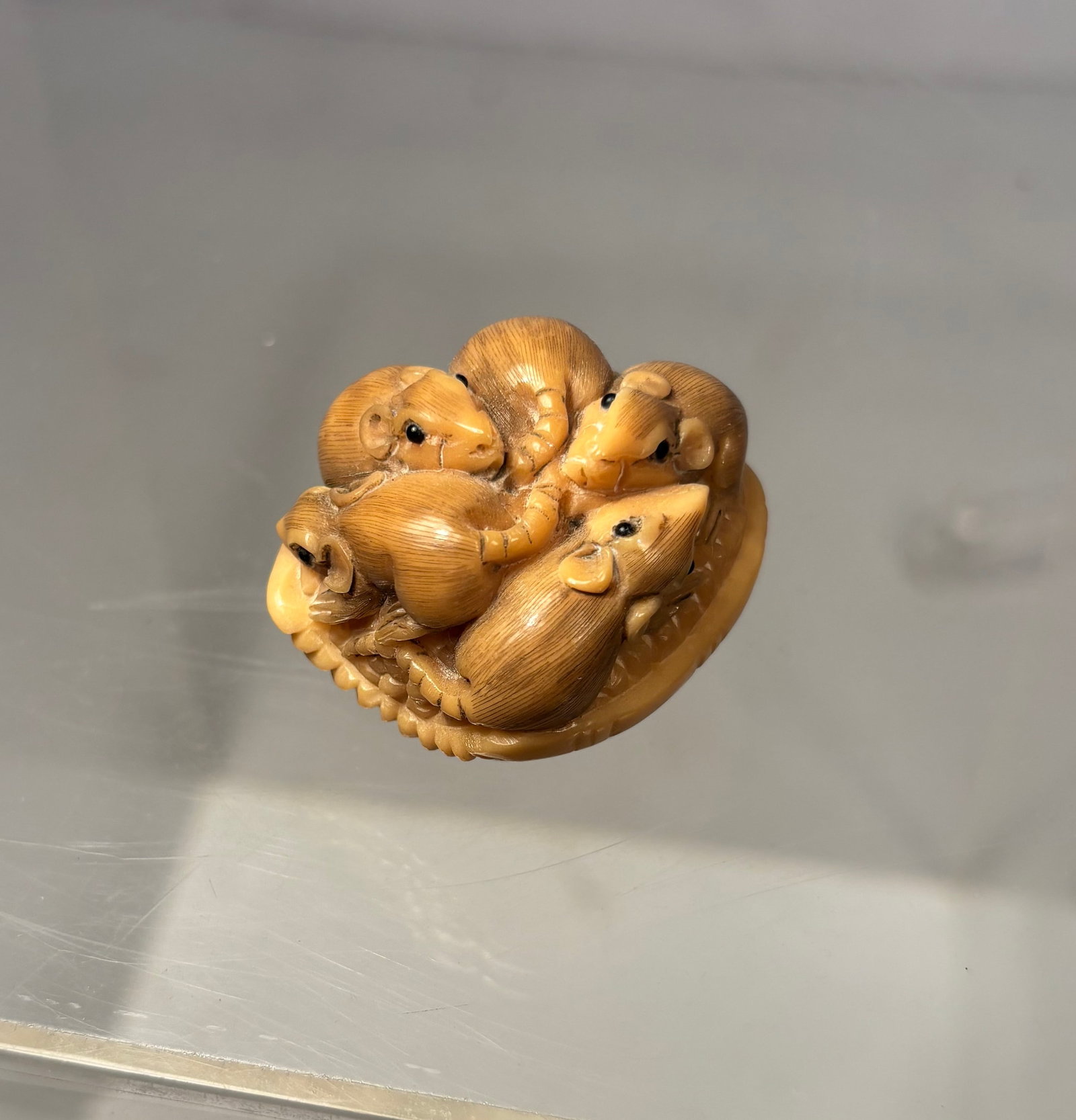 19th C. Japanese Tagua Nut Netsuke of Rats in a Woven Basket, Signed Horaku: Finely carved Japanese netsuke depicting a lively group of rats clustered within and around a woven basket. The rats are individually modeled with expressive features, finely incised fur, curling tail