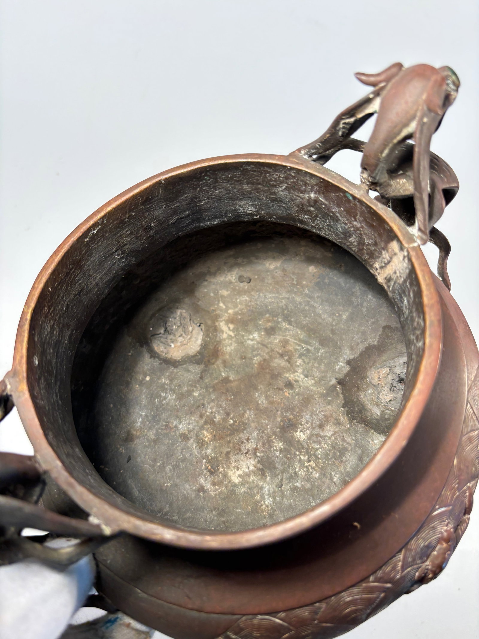 A Chinese gilted Bronze Tripod Censer with Lion-Dog Finial with sign "DA MING XUAN DE YAN ZHI": Qing dynasty(1644-1912); Of baluster form raised on three curved legs, the censer features a pierced domed cover surmounted by a seated lion-dog (Bixie or Buddhist lion) with exaggerated features and 