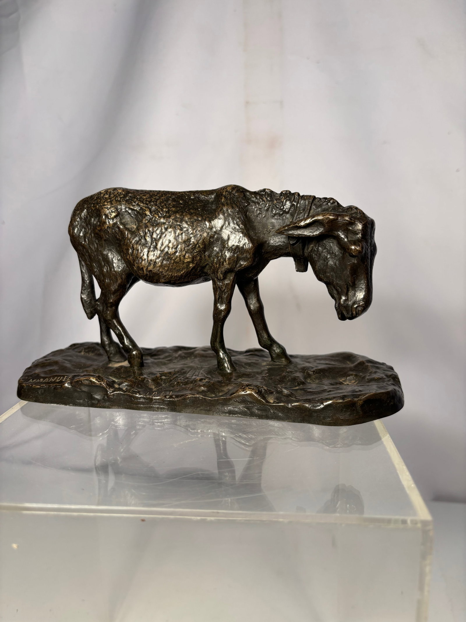Signed “EMMANUEL?? French Animalier Bronze Bovine Sculpture, Dated 1841: Cast bronze sculpture depicting a standing cow with its head lowered in a naturalistic grazing pose atop an integral textured base. Executed in the French Animalier style, the sculpture features expre
