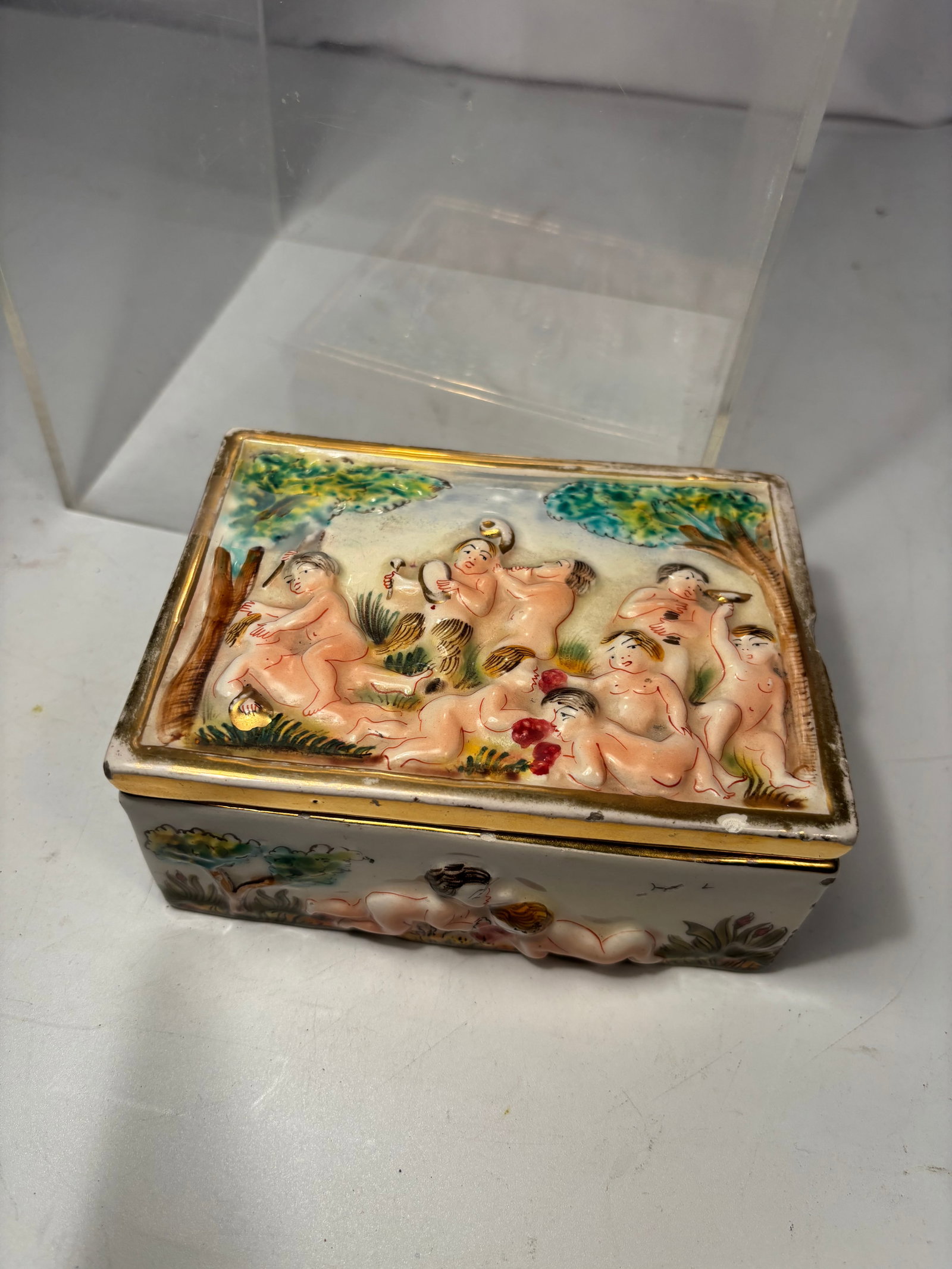 Italian Capodimonte-style porcelain trinket box: This is a vintage Italian Capodimonte-style porcelain trinket box featuring a hand-painted, high-relief mythological scene of frolicking cherubs (putti) . Marked with a crowned “N,” “G12,&rd