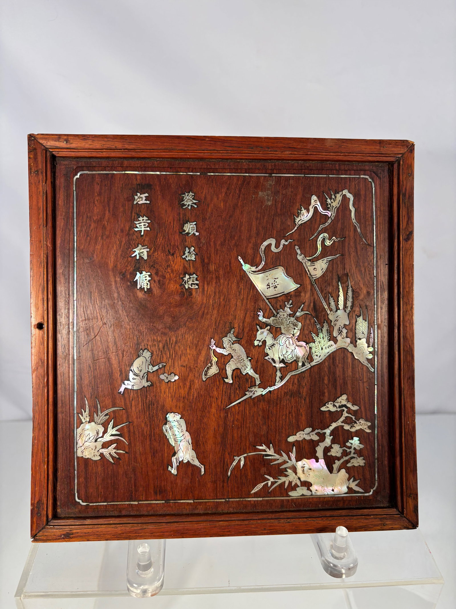 A Chinese Huanghuali and Mother-of-Pearl Inlaid Panel: Late 19th Century; A rectangular huanghuali wood panel inlaid with mother-of-pearl, depicting a procession of warriors with banners in a mountainous setting with pine and bamboo, together with a