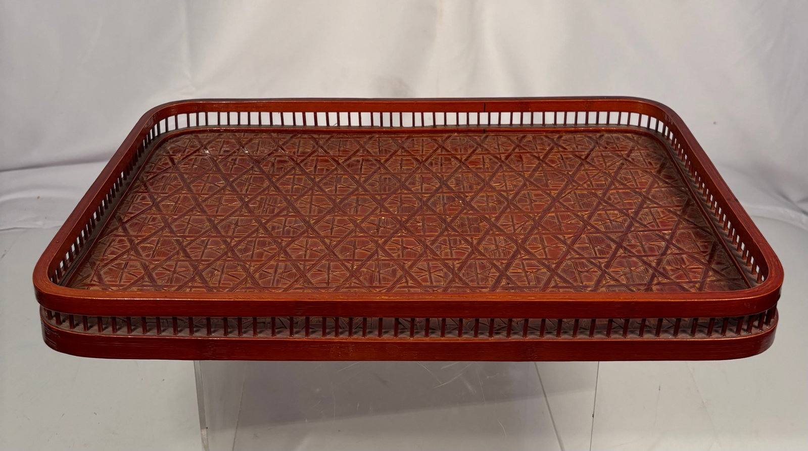 Japanese Woven Bamboo Tea Tray: A Japanese rectangular bamboo tea tray (chabon), featuring a woven bamboo surface with an openwork gallery rim and rounded corners. The tray has a warm amber-brown patina and was designed for serving 