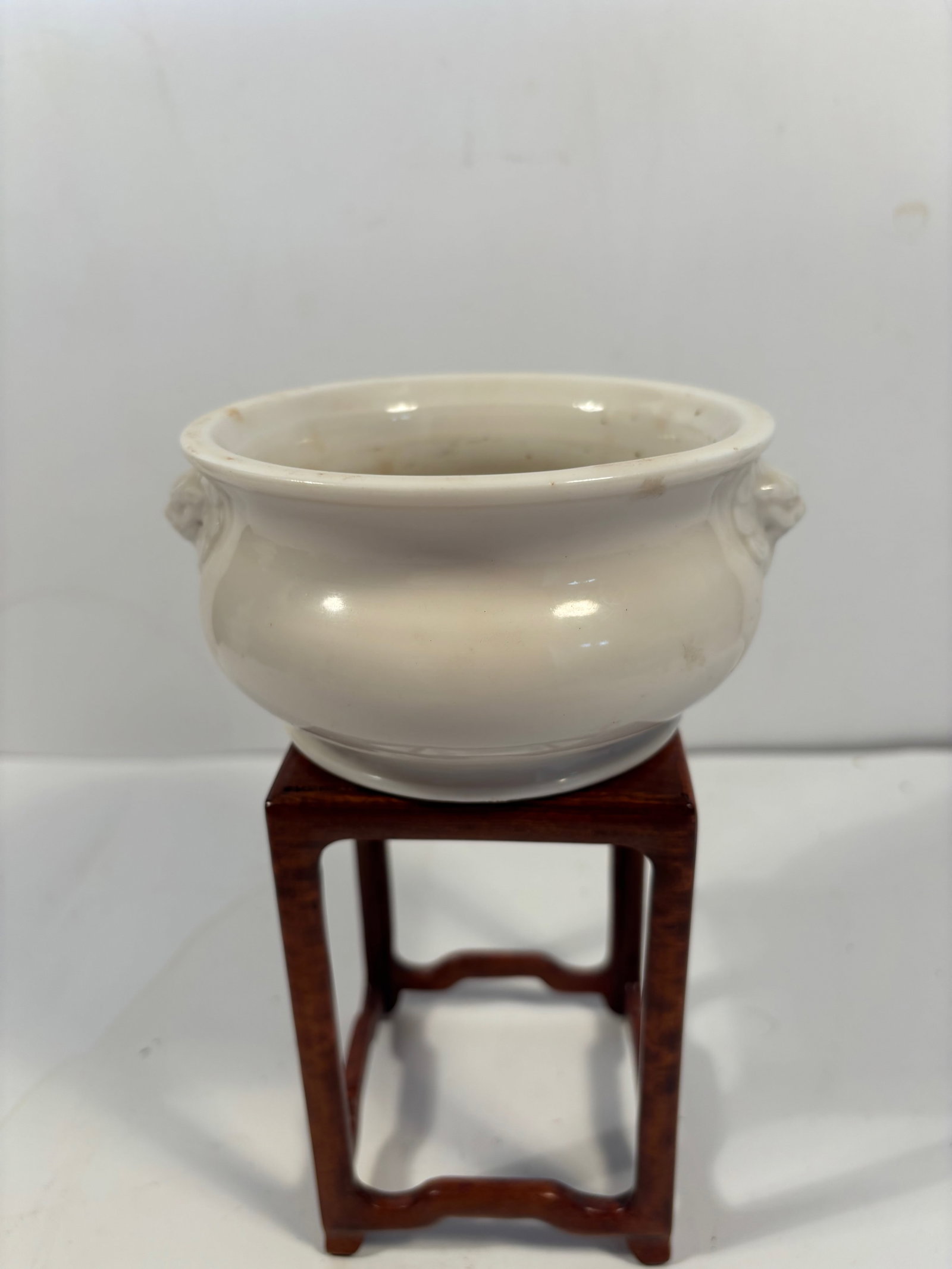 A Chinese blanc-de-chine porcelain Censer: Qing Dynasty (1644-1912) ;blanc de chine porcelain censer, round form with foo lion head handles. Dimensions?3" H x 5.5" diameter.