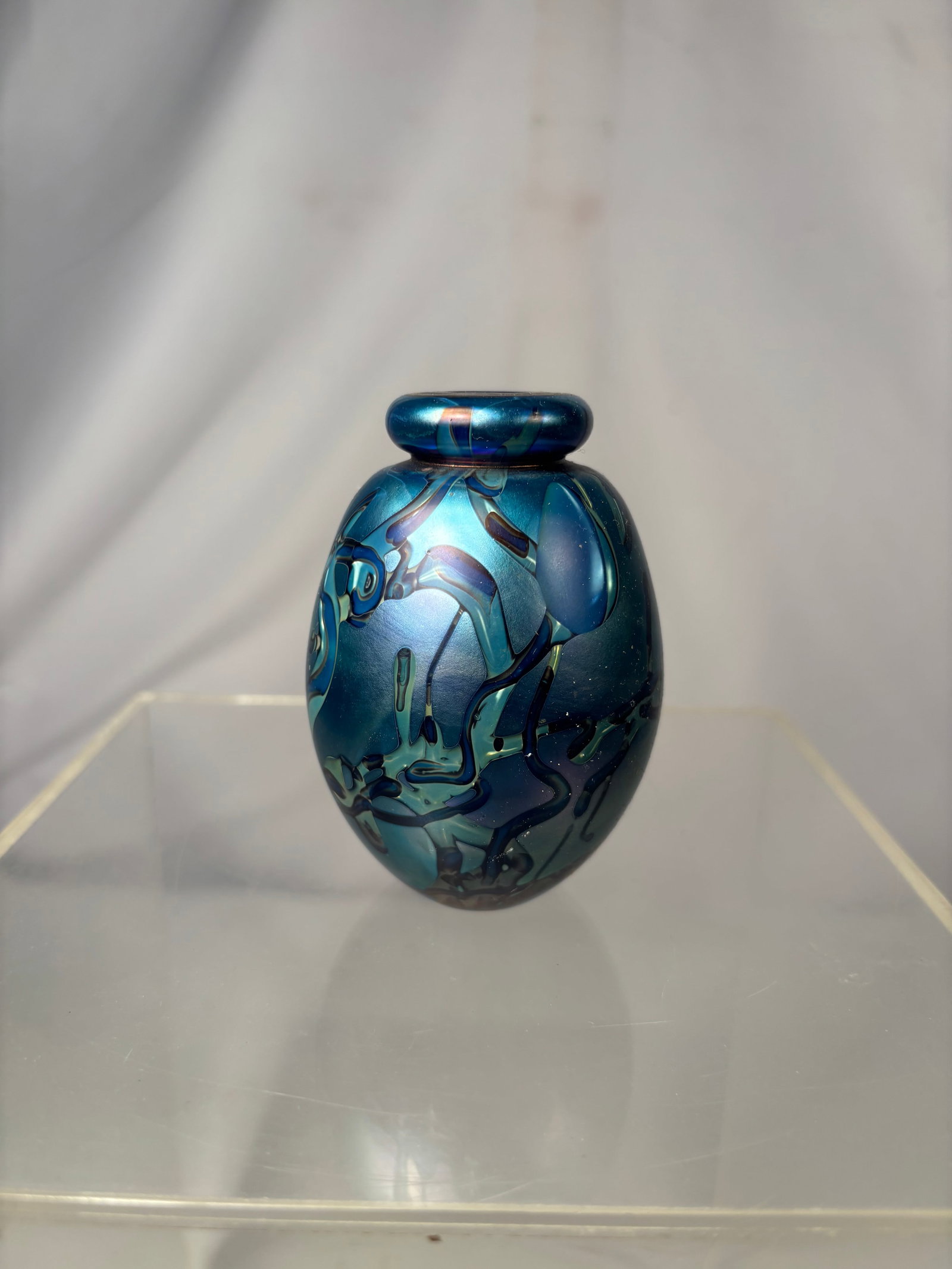 Robert Eickholt Signed Iridescent Blue Art Glass Vase: A signed Robert Eickholt handblown studio art glass perfume bottle, dated 1998. The rounded vessel features a deep cobalt-blue ground with vibrant iridescent abstract patterns in turquoise, aqua, purp