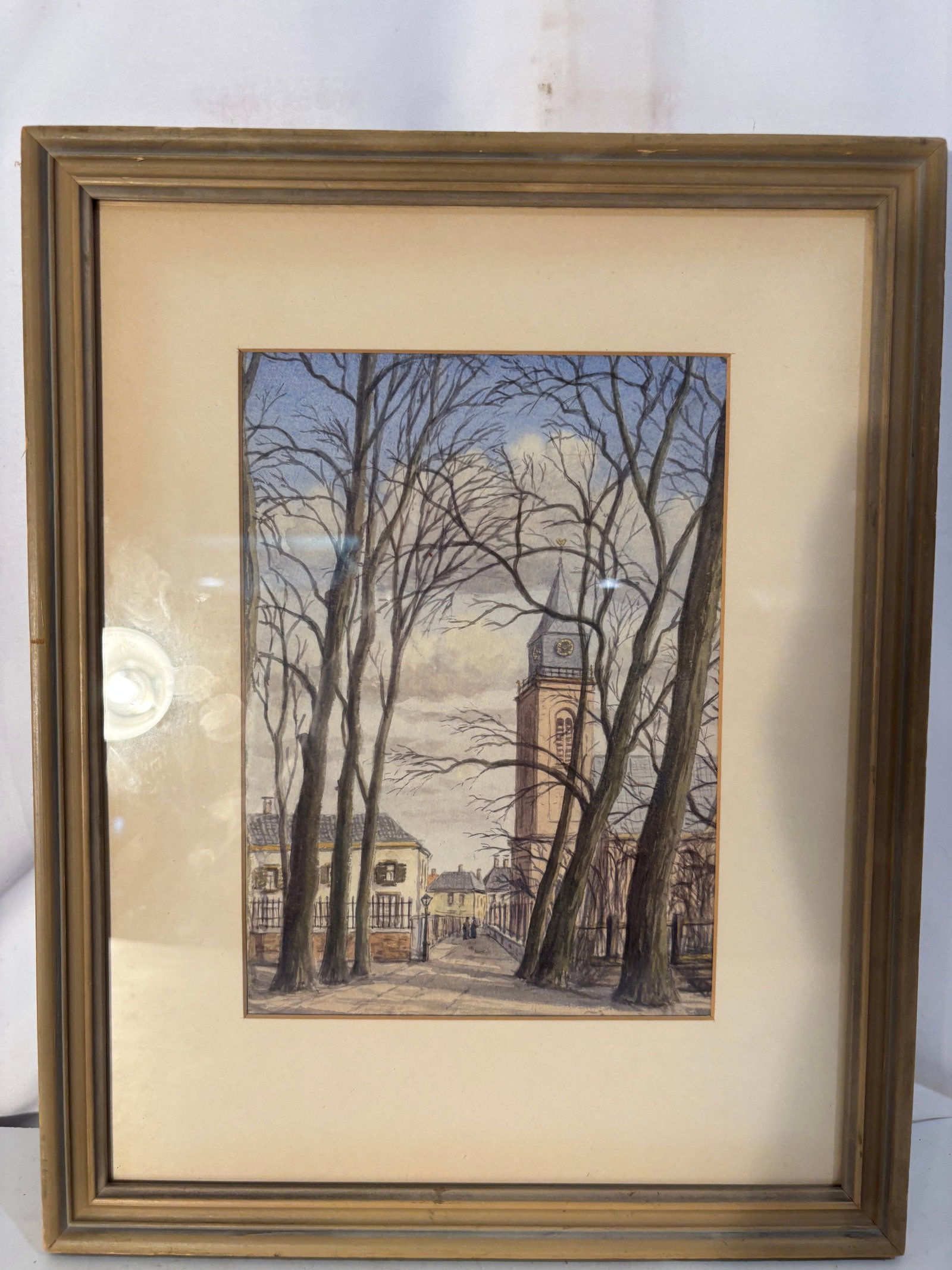 Willem Voerman (Dutch, 1894–1968), Werkendam, Holland, Watercolor and Ink on Paper: A Dutch townscape by Willem Voerman depicting a church tower viewed through a grove of tall, leafless trees in Werkendam, Holland. Executed in watercolor and ink on paper in a restrained palette of bl