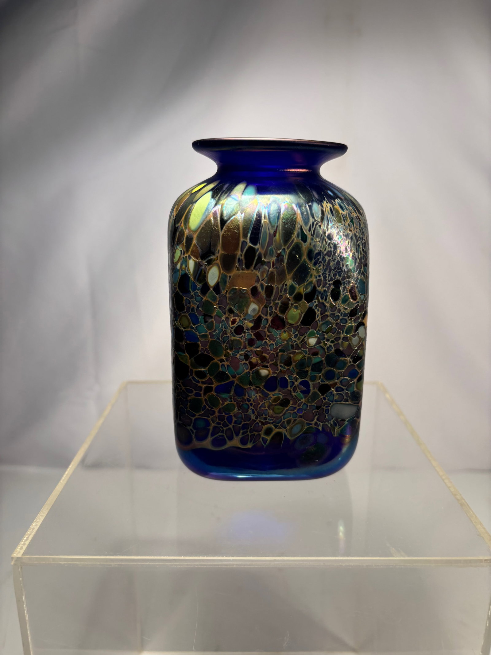 A Signed Art Glass Vessel, Dated 1994: Hand-blown art glass vessel with a rounded, organic form, executed in deep cobalt blue glass with iridescent highlights and internal mottled inclusions that create a shimmering, cellular effect. The s