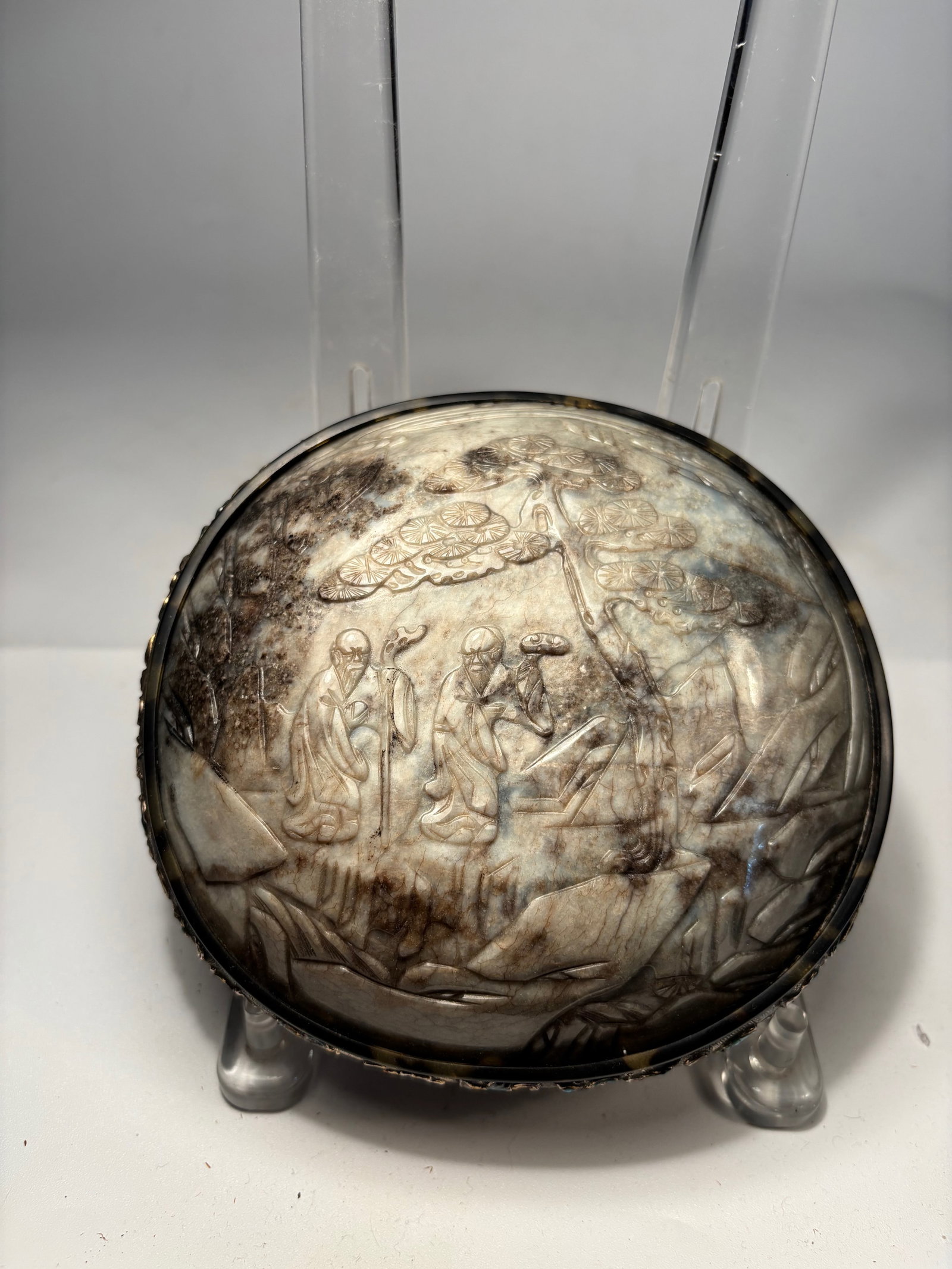 A Chinese Jade Carved Lid Box with Cloisonné Enamel Rim: Qing dynasty(1644-1912); An exquisite antique Chinese box featuring a carved jade lid depicting a serene scene of scholars in a mountainous landscape under swirling clouds and pine trees — a motif r