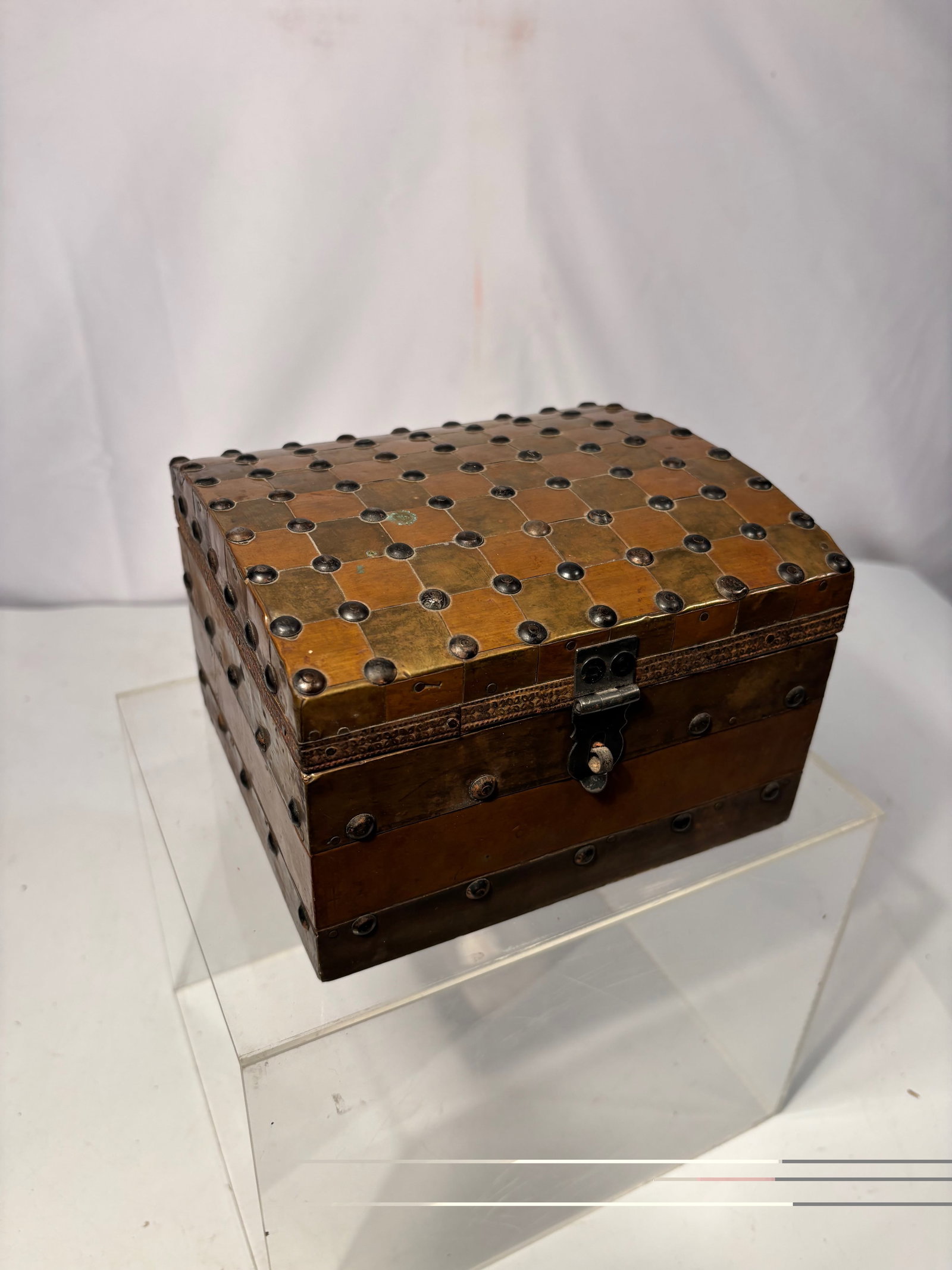 Antique Anglo-Indian / European Colonial Copper & Brass Jewelry Box: Antique domed-top jewelry box, constructed with a wooden core clad in alternating copper and brass panels. The exterior is richly decorated in an allover geometric grid with raised studded bosses, cre