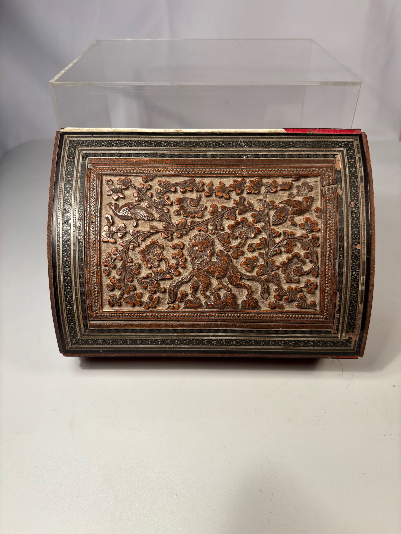 An Anglo-Indian Vizagapatam Sandalwood Box with Micro Mosaic Inlay, 19th Century: A finely carved Anglo-Indian Vizagapatam sandalwood box, the lid decorated with intricate foliate scrollwork and a central mythical beast in relief, framed by geometric borders. Vizagapatam boxes from